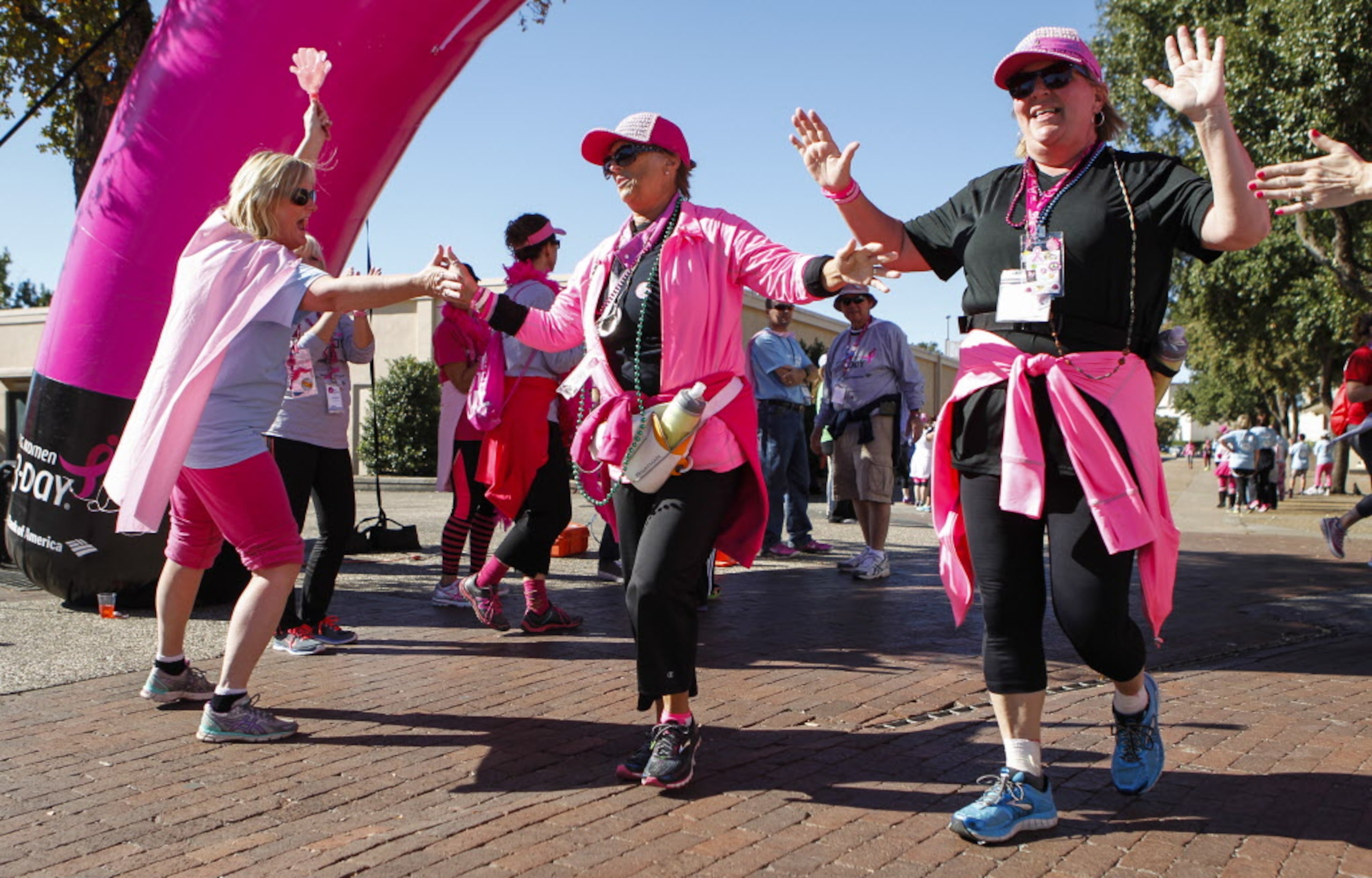 Volunteer Kathy McKichan (left) congratulates Elaine Smith of Allen, Texas and Donna George...