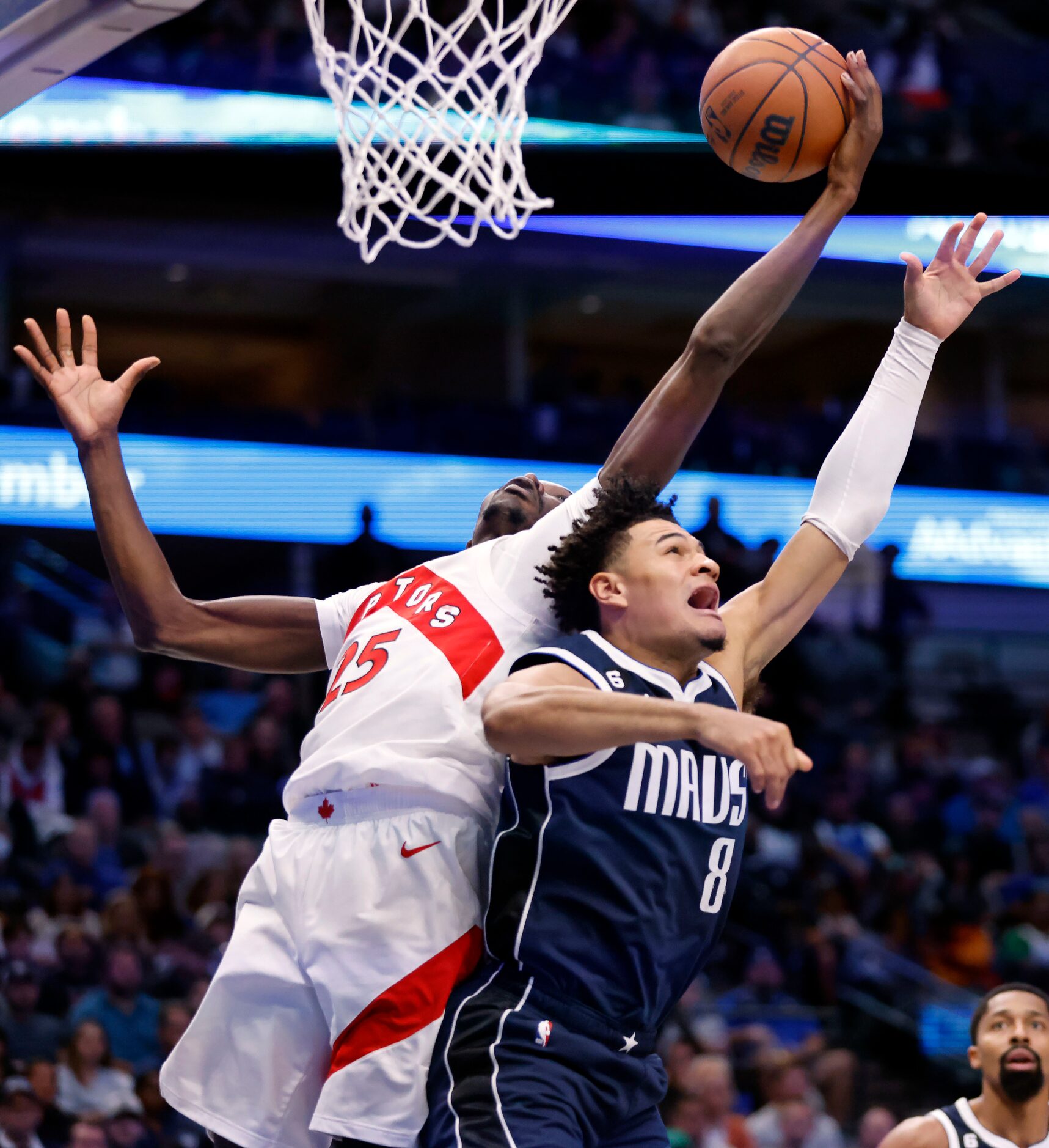 Dallas Mavericks guard Josh Green (8) battles Toronto Raptors forward Chris Boucher (25) for...