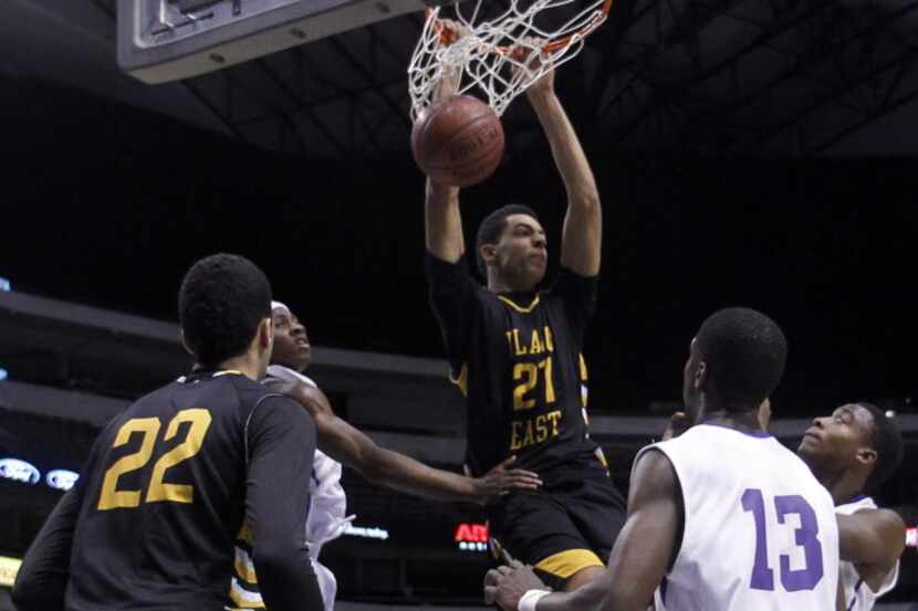 Plano East player Zach Smith dunks the ball during a basketball game versus Dallas Lincoln...