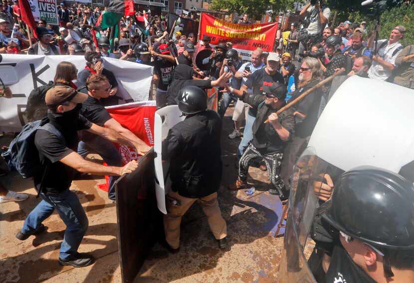 White supremacists clash with counterdemonstrators at the entrance to Lee Park in...