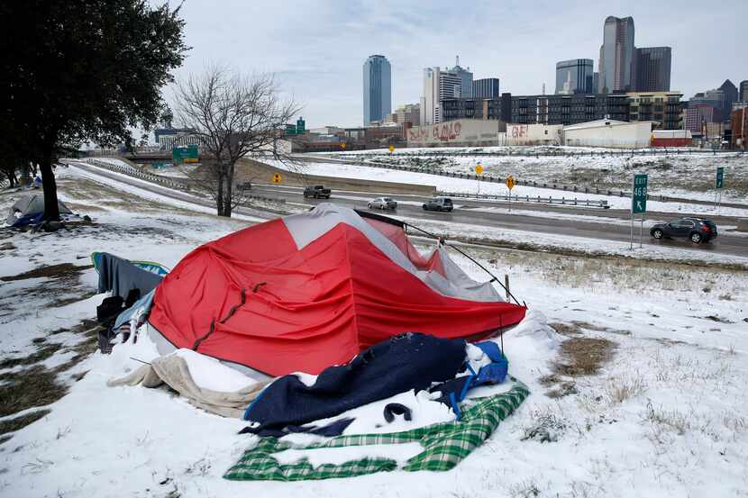 Snow-covered tents pitched along Interstate 30 were abandoned by their owners as a snowstorm...