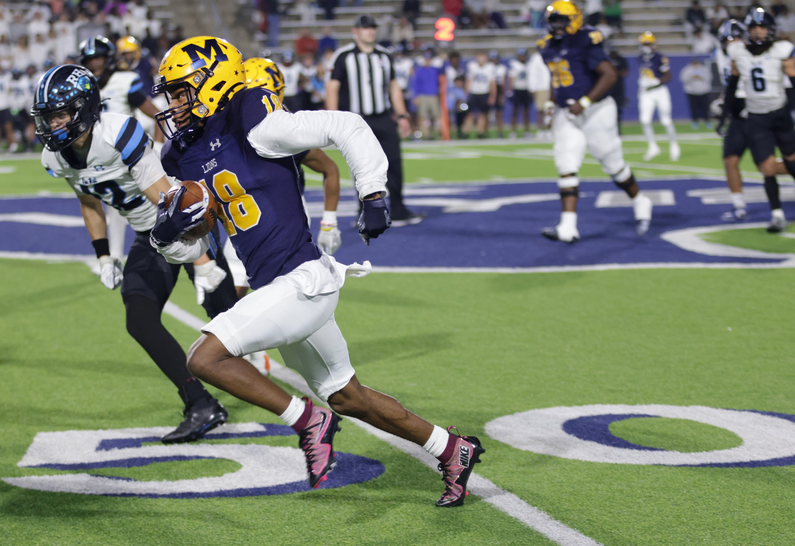 McKinney player #18 Jacoby Propes runs the ball for a first down during the Prosper Rock...