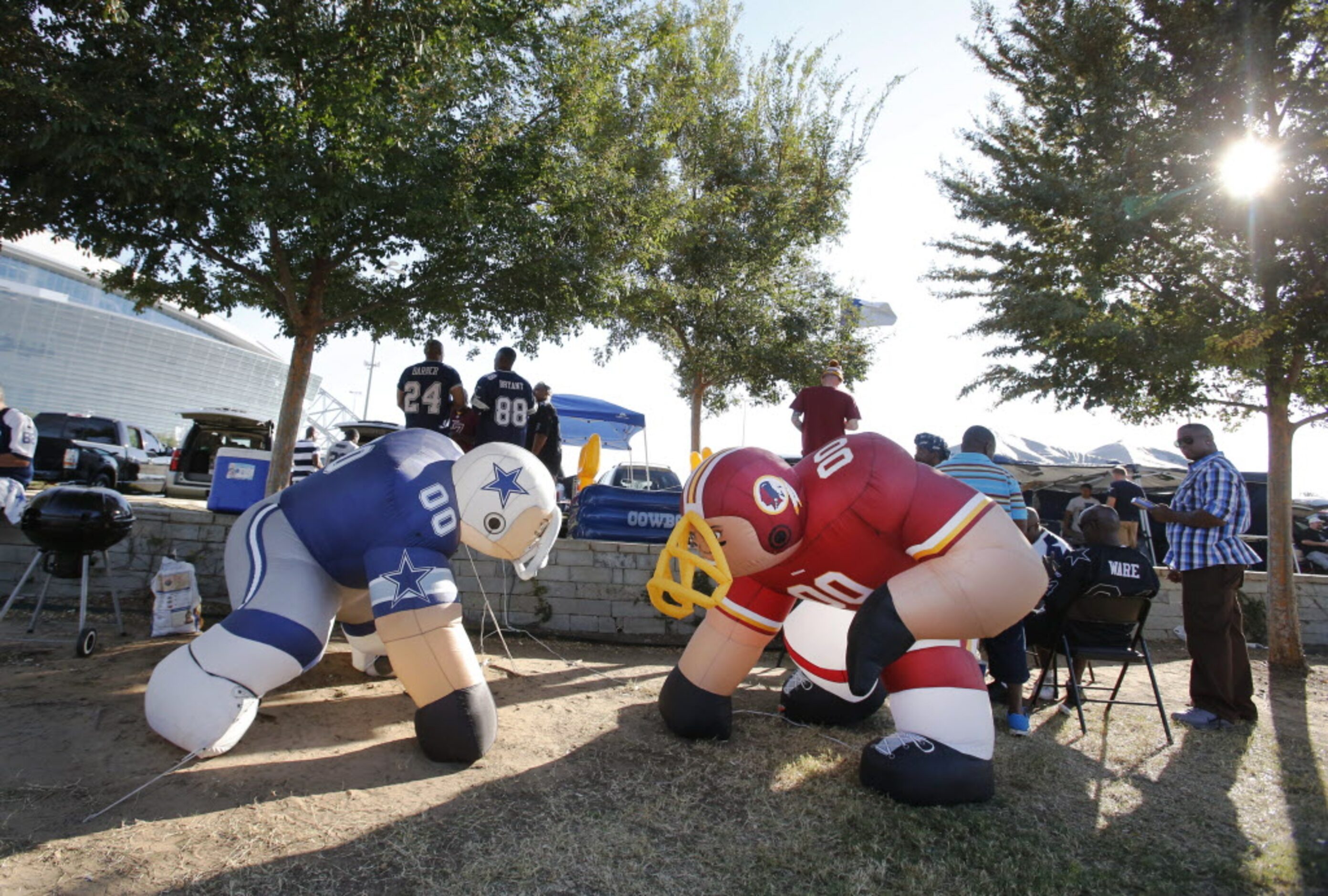 Two large inflatables catch the sun along Randol Mill Street as fans tailgate before the...