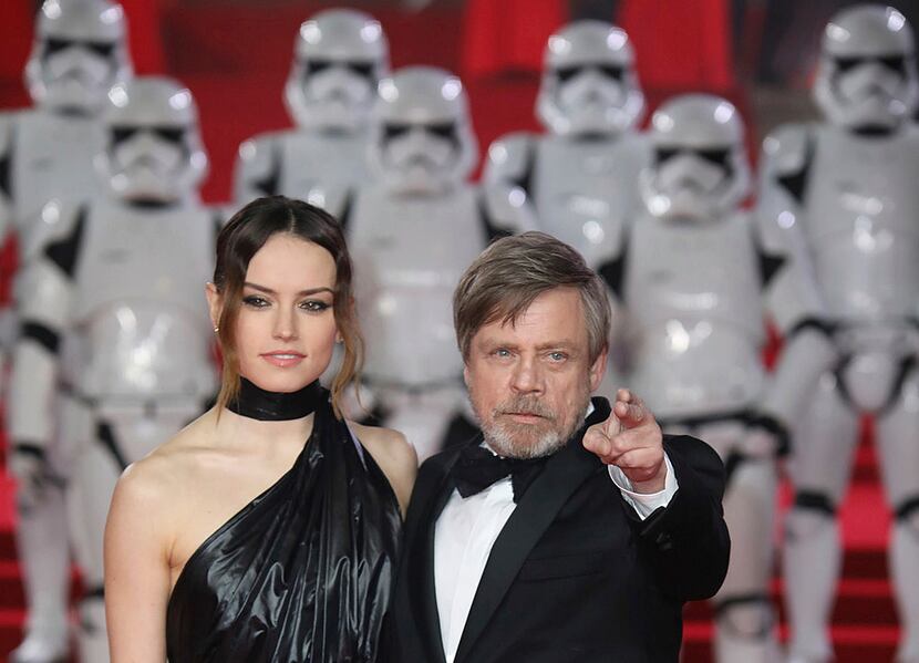 Actors Daisy Ridley, left, and Mark Hamill pose for photographers upon arrival at the...