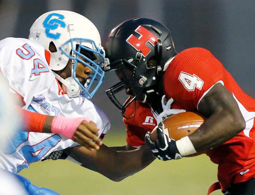 Hillcrest High running back Nasir Reynolds (4) comes face-to-face with defensive end Randy...