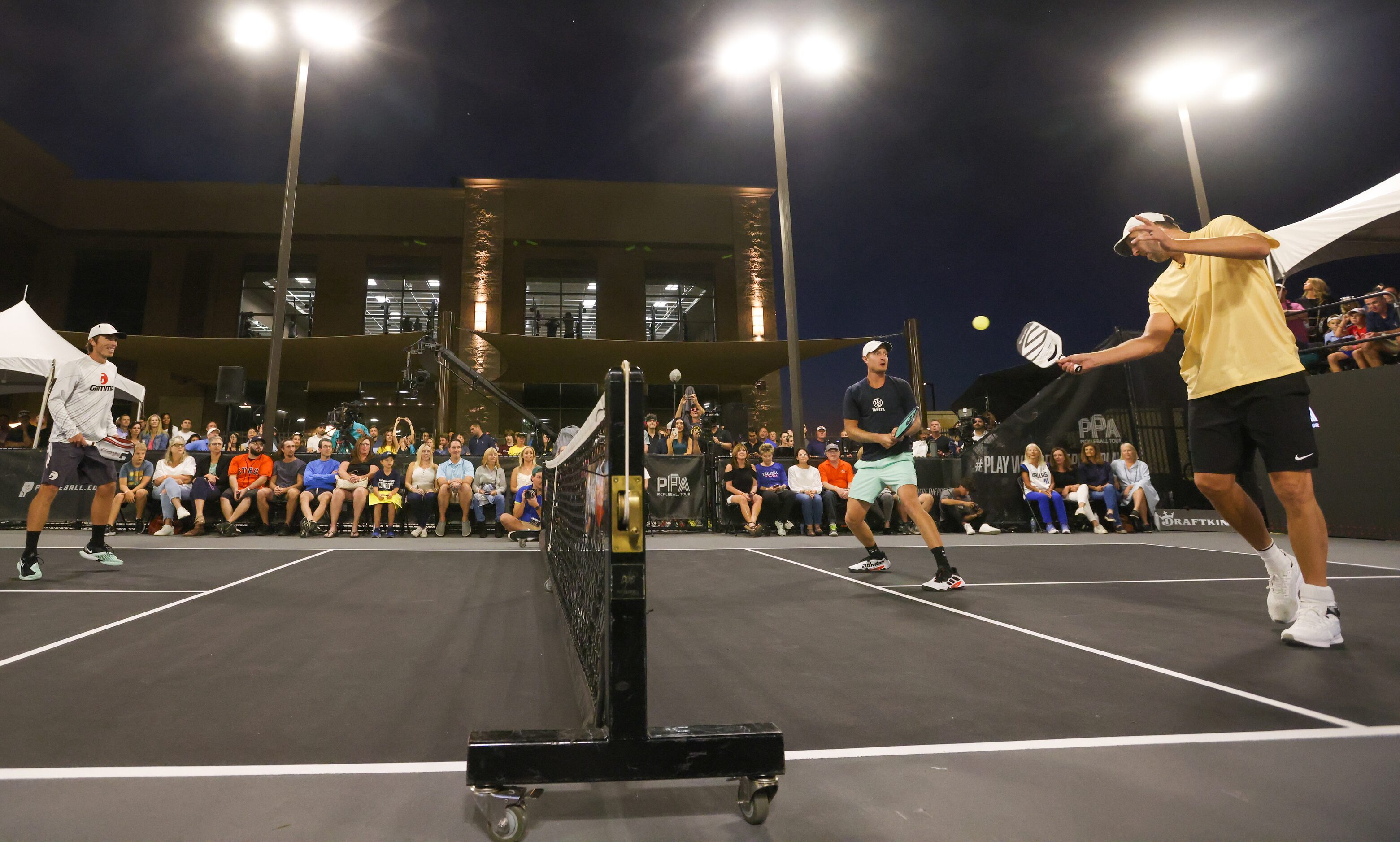 Spencer Smith (left), Riley Newman and Dirk Nowitzki (right) play a match of doubles...