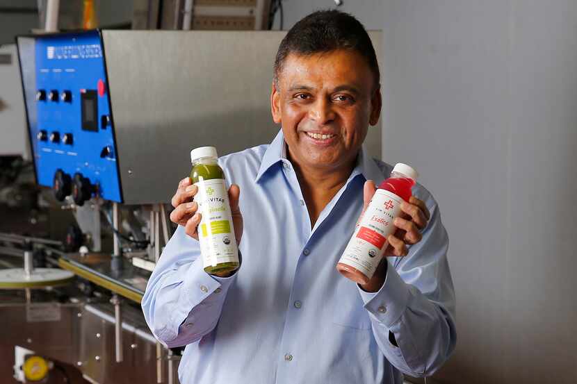 Vim Vitae CEO Nick Mysore poses with some of their natural, organic juices they produce at...