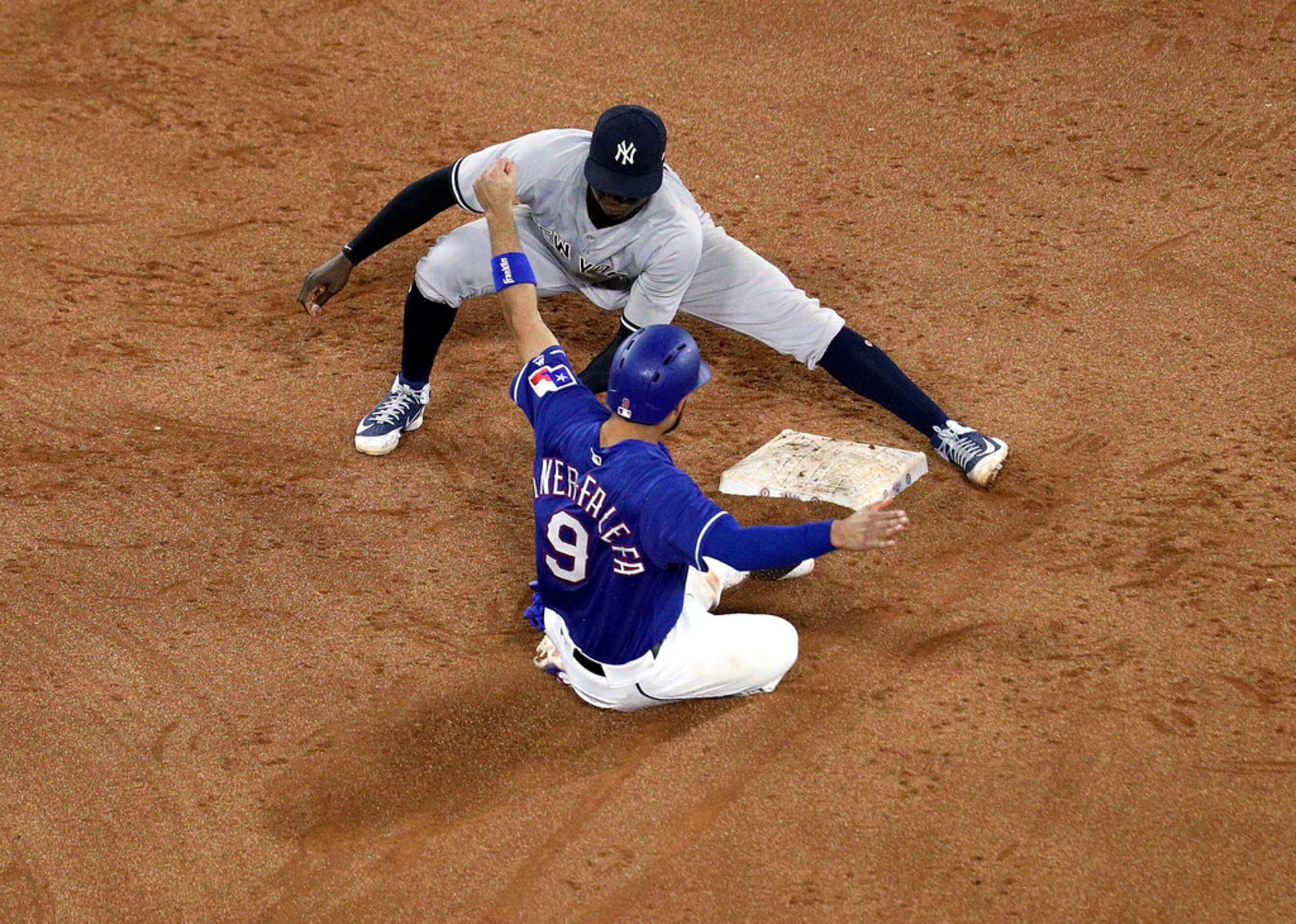 ARLINGTON, TX - MAY 23:  Isiah Kiner-Falefa #9 of the Texas Rangers steals second base as...