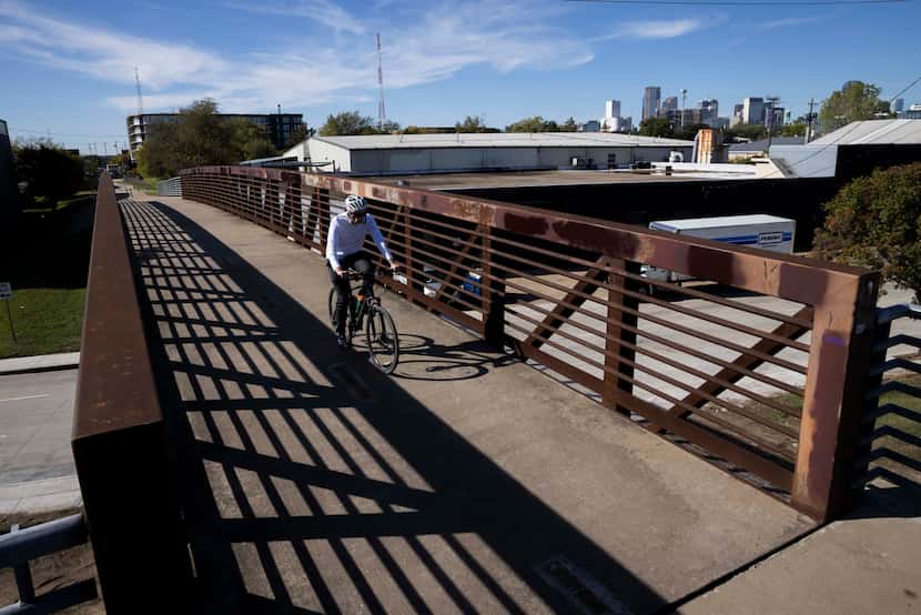 A cyclist on one of the elevated sections of the Santa Fe Trail, not far from Deep Ellum,...