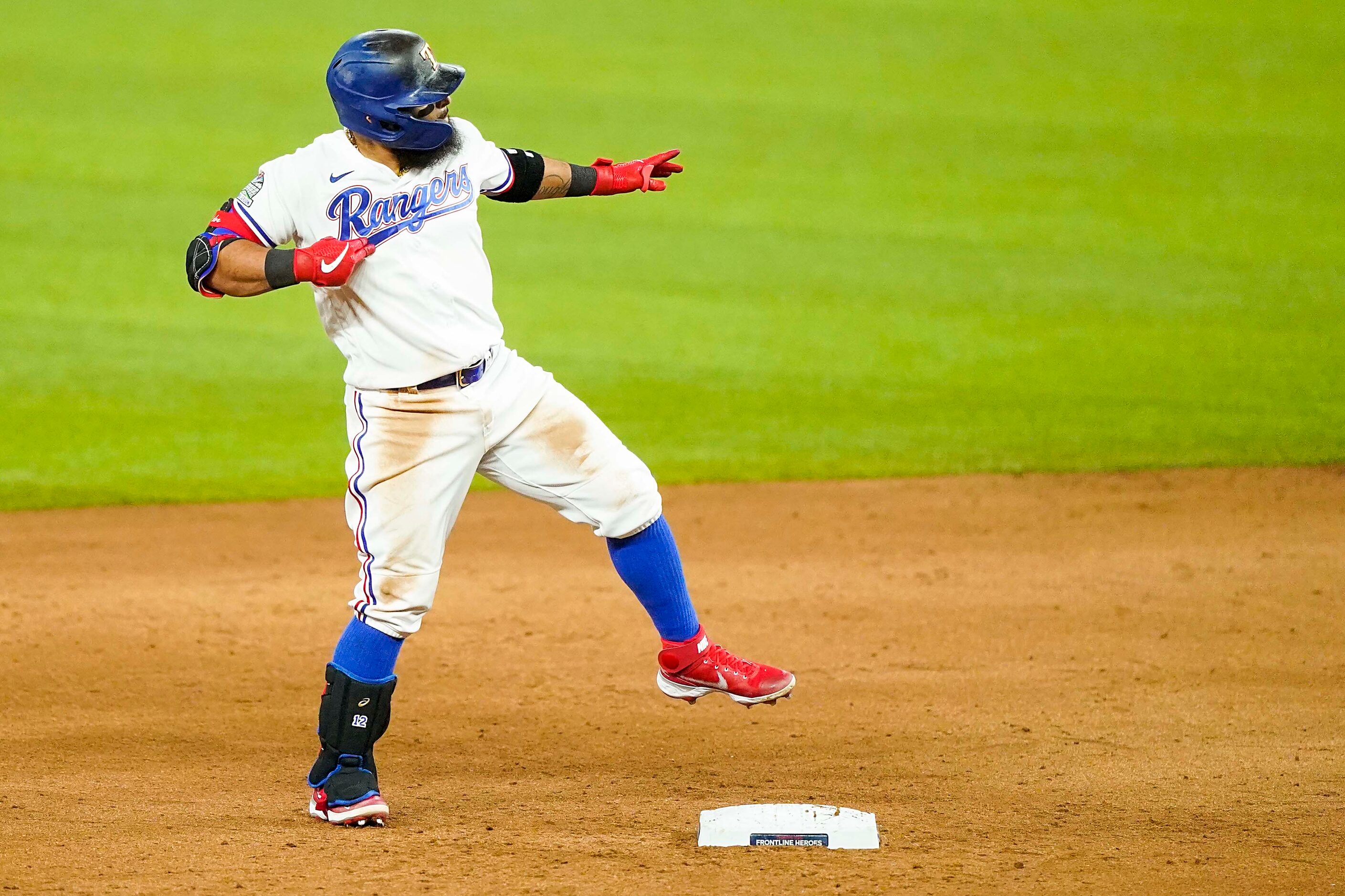 Texas Rangers second baseman Rougned Odor celebrates as second base after hitting an RBI...