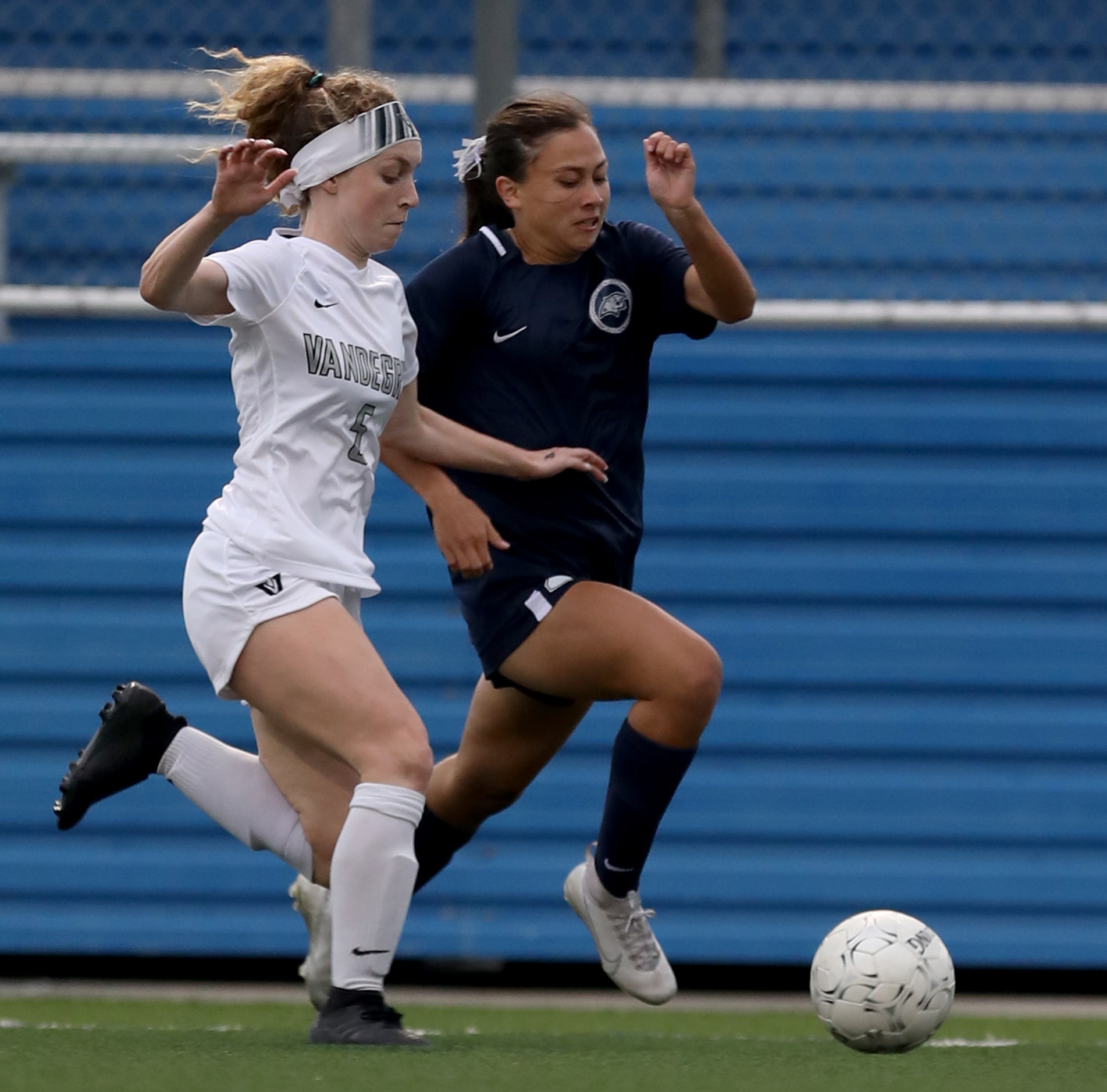 Austin Vandegrift's Addie Carriere (5) and Lewisville Flower Mound's Emma Hoang (23) chase...