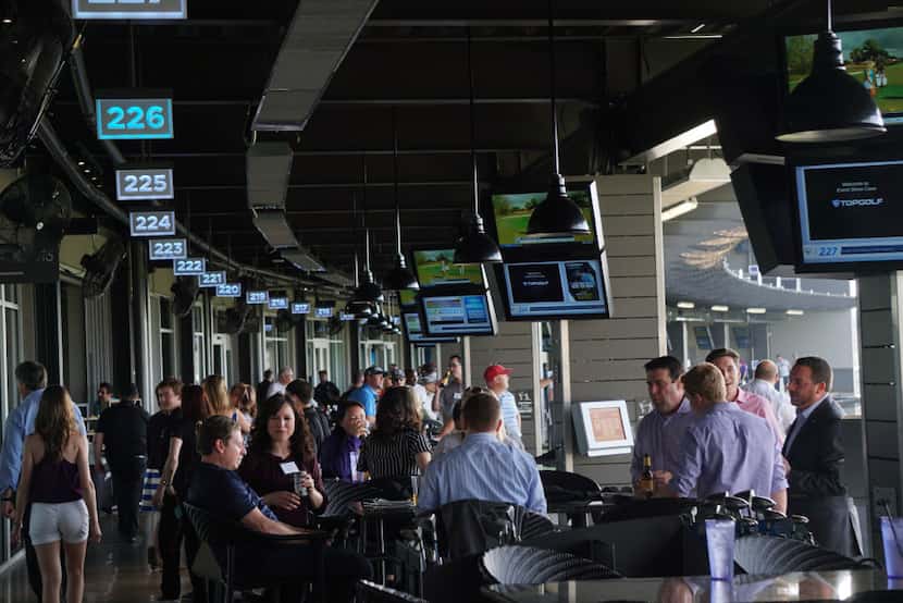 Patrons enjoy themselves at media night at the new TopGolf in Fort Worth, Texas on April 25,...