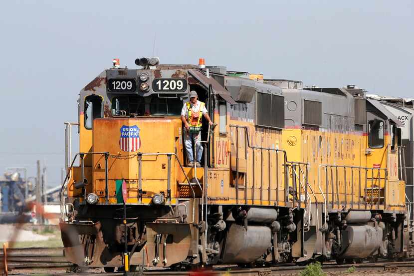 FILE - In this Thursday, July 20, 2017, file photo, a Union Pacific employee uses a remote...