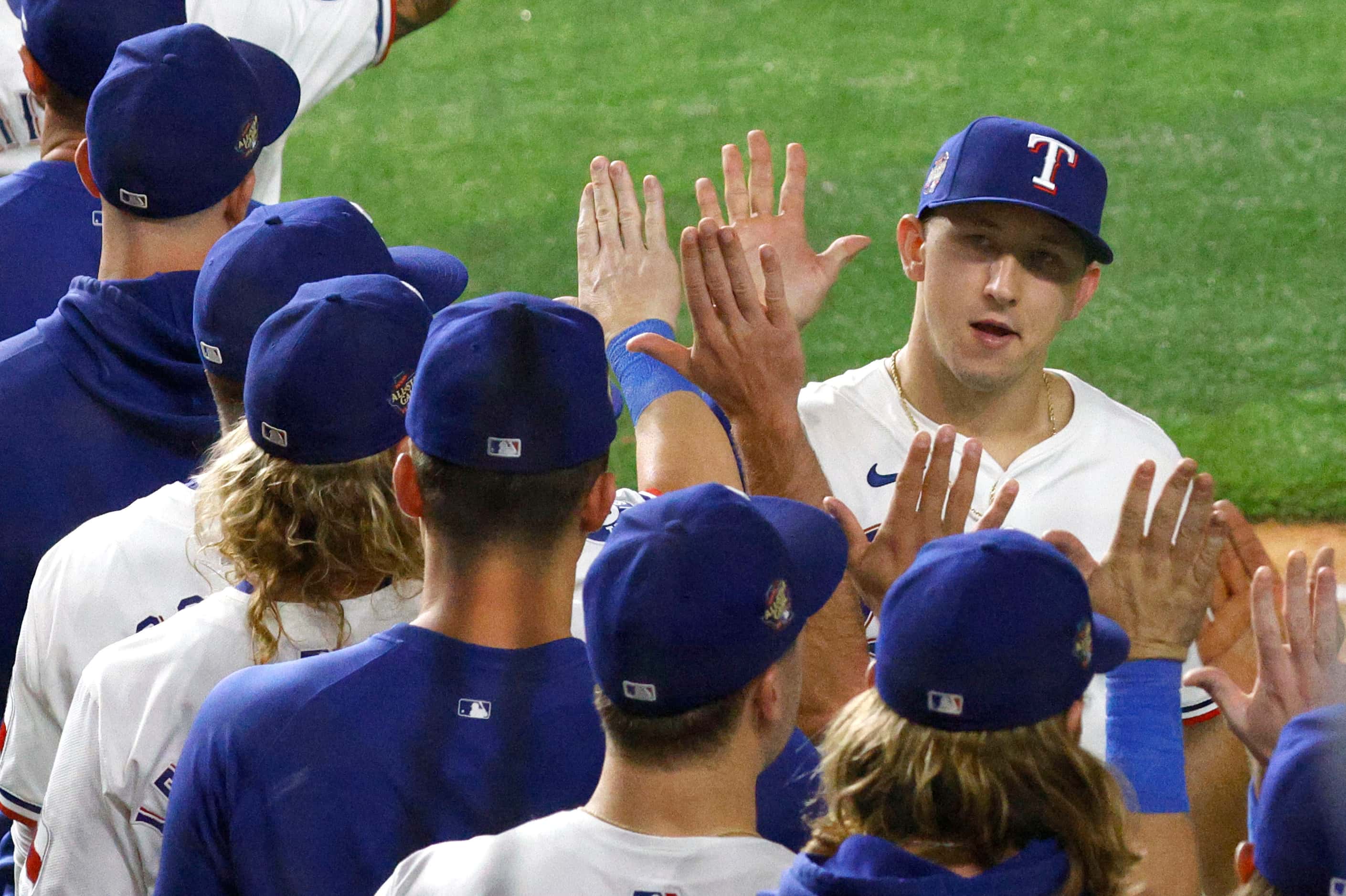Texas Rangers outfielder Wyatt Langford (36) celebrates with his teammates their victory...