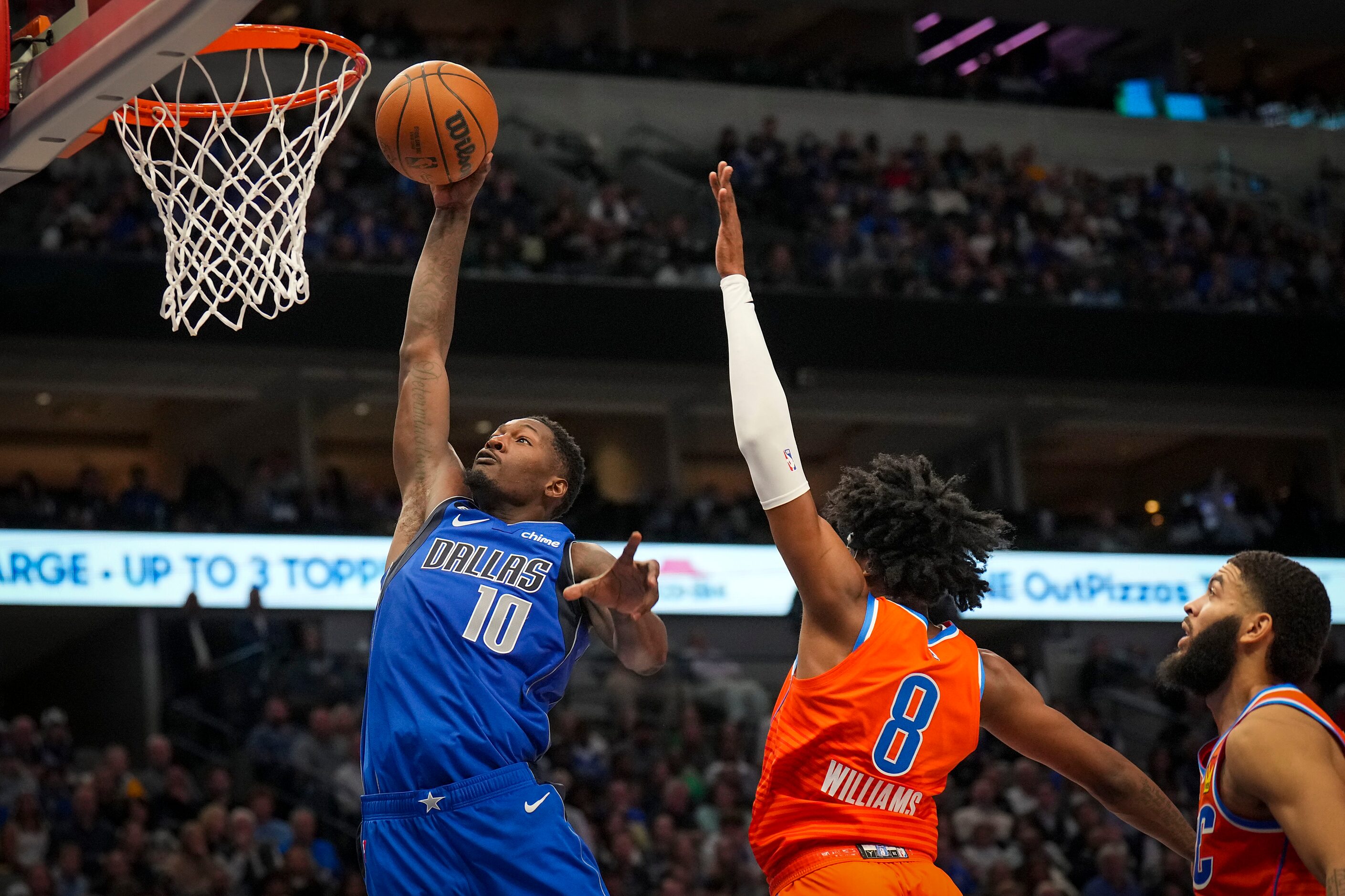 Dallas Mavericks forward Dorian Finney-Smith (10) dunks the ball past Oklahoma City Thunder...