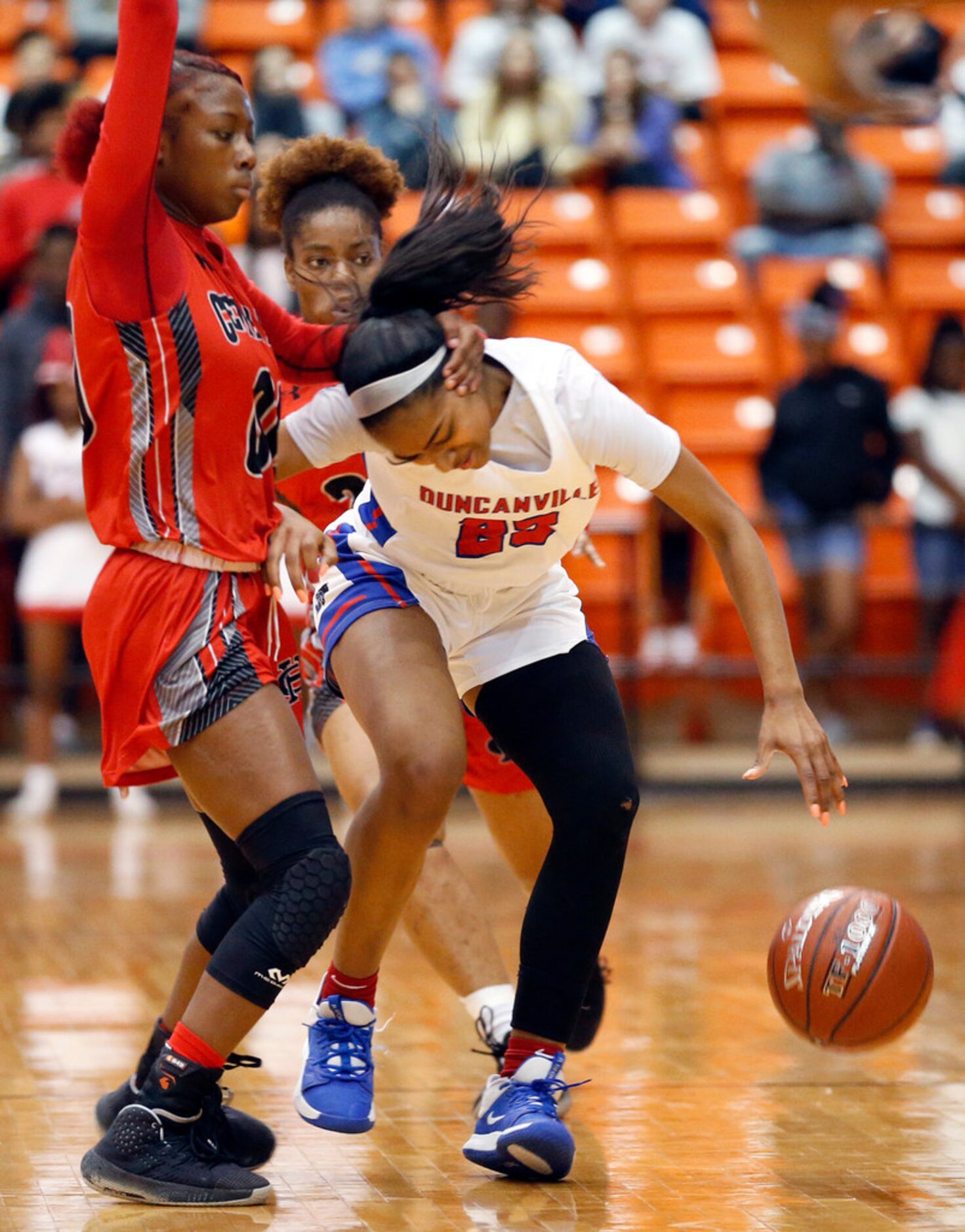 Duncanville's  Deja Kelly (25) is fouled by Cedar Hills' Makalah Robinson (00) as she tries...