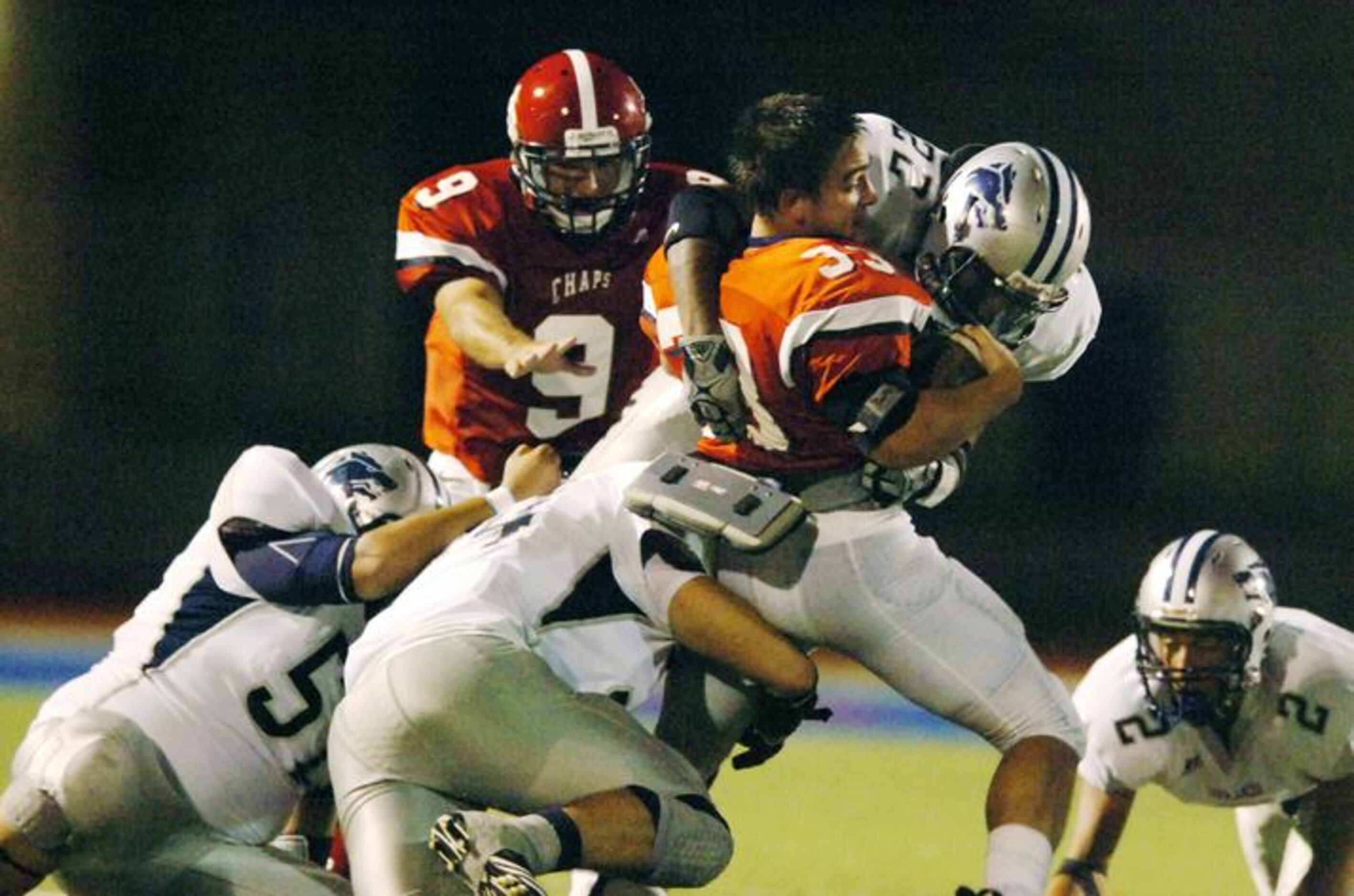 After loosing his helmet Aubrey senior running back Justin Griffin (33) fights off...