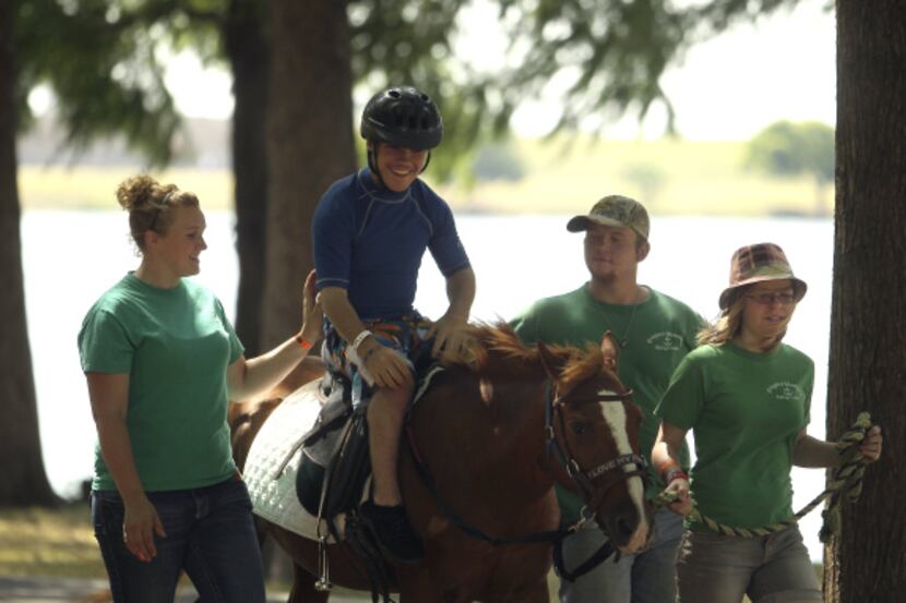 Jason Lauchner, 13, of Grand Prairie enjoyed a horseback ride with help from his sister...