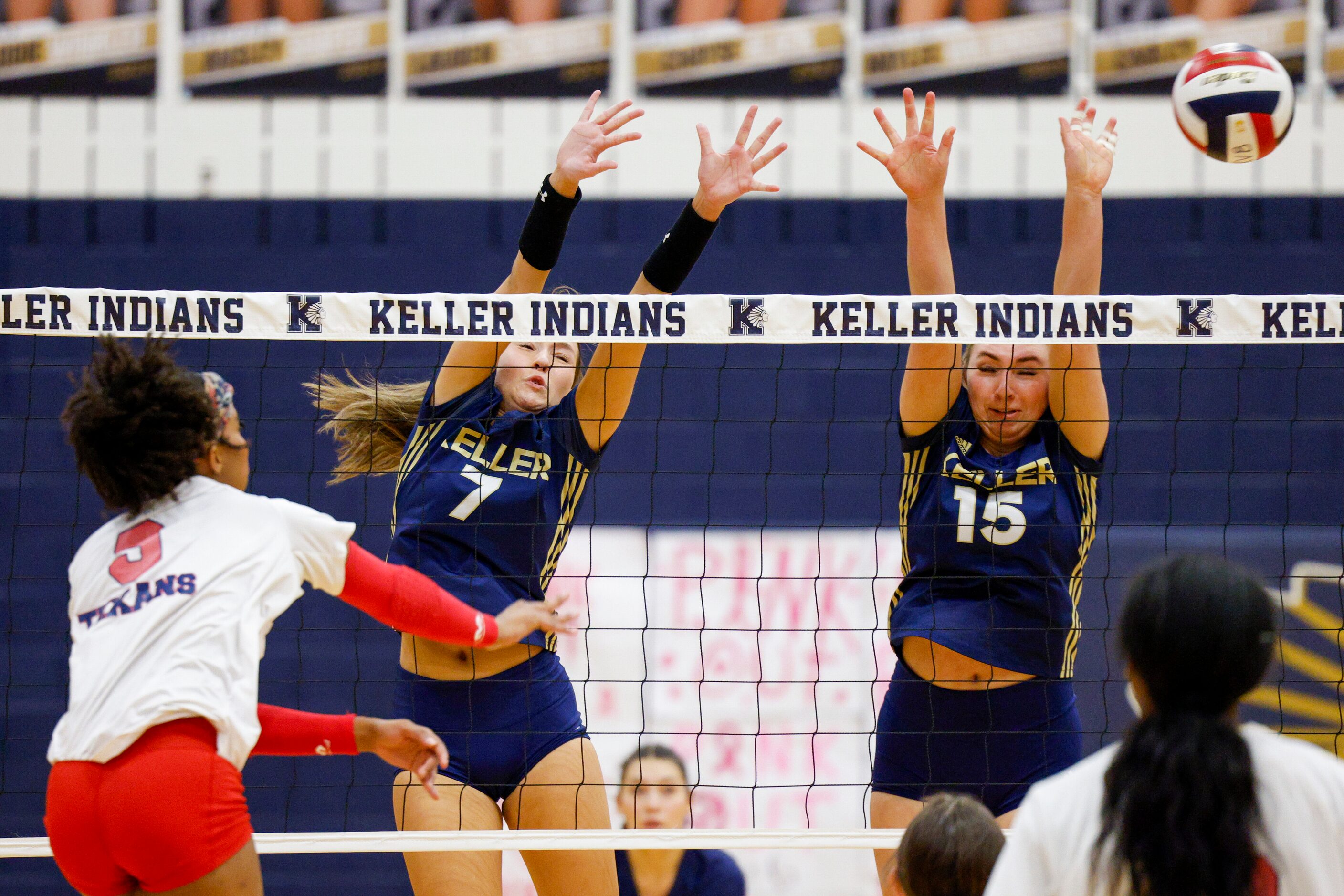 Justin Northwest's Ariah Perez (9) hits around the block of Keller's Carley Wright (7) and...