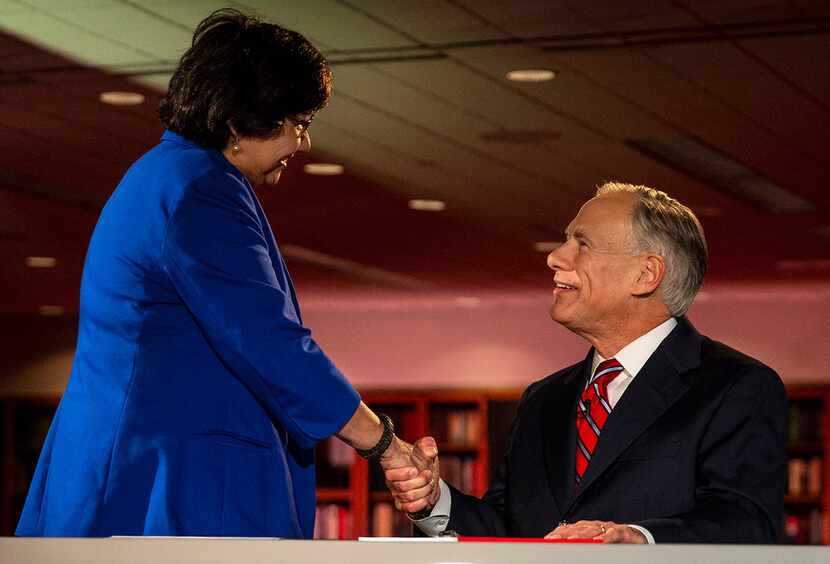 Texas Governor Greg Abbott shakes hands with Lupe Valdez, his Democratic challenger, before...