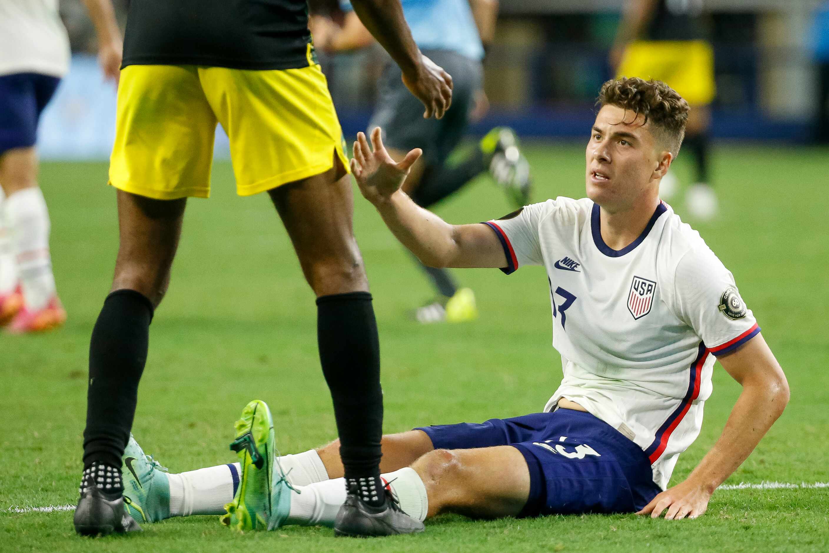 USA forward Matthew Hoppe (13) is helped up by a Jamaica defender during the second half of...