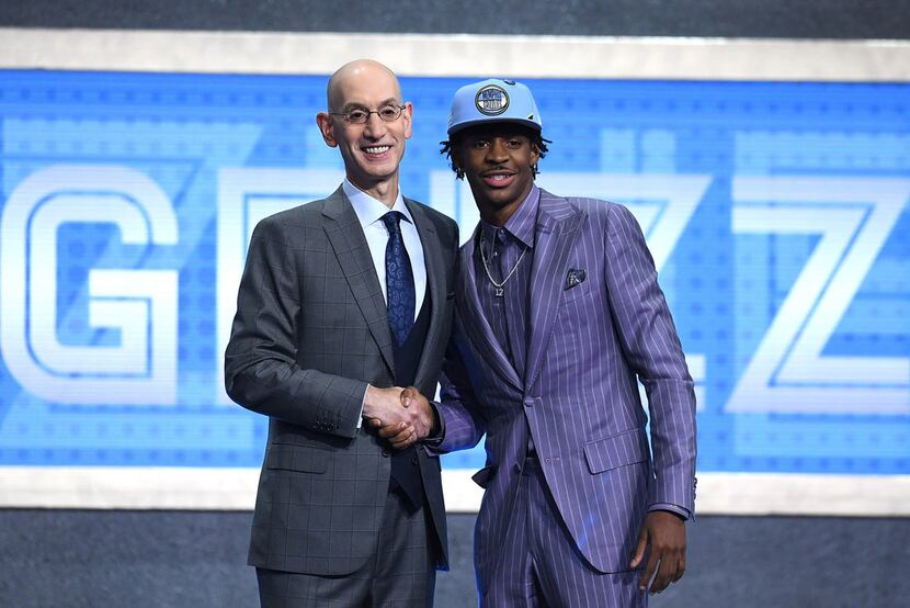 Ja Morant poses with NBA Commissioner Adam Silver after being drafted with the second...