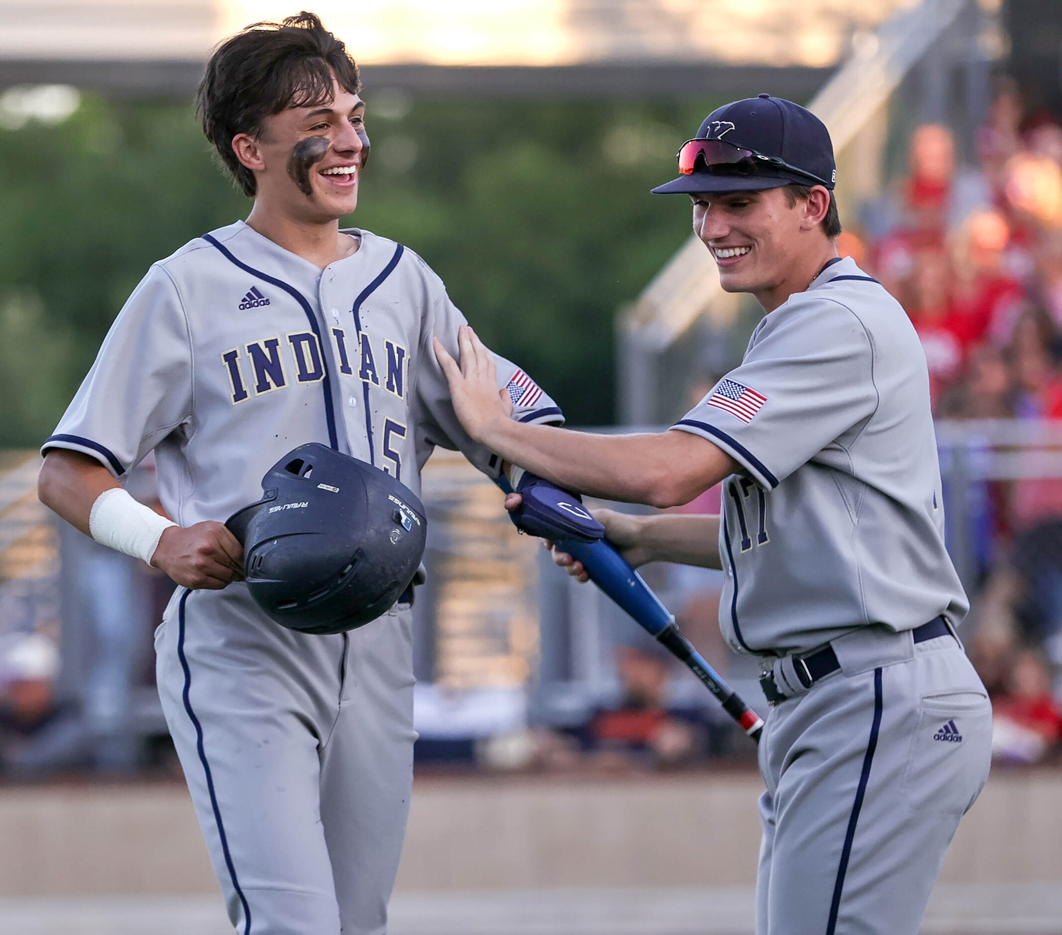 Keller center fielder Jackson Hill (5) is greeted by Jackson Renz after scoring a run...