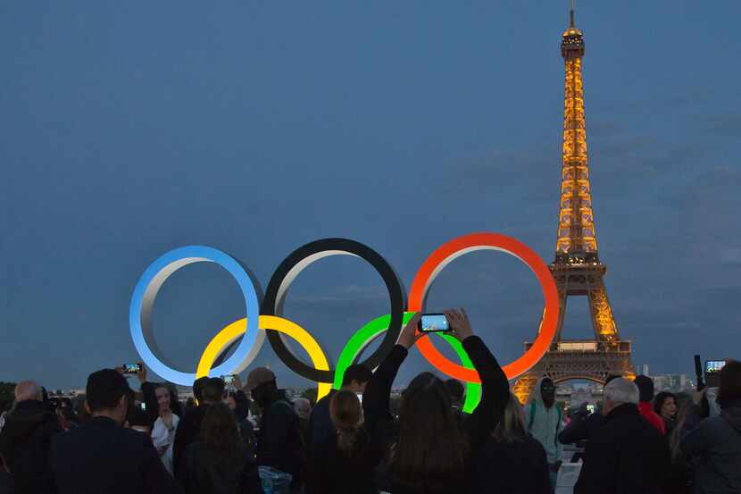 FILE - The Olympic rings are set up on Trocadero plaza that overlooks the Eiffel Tower, a...