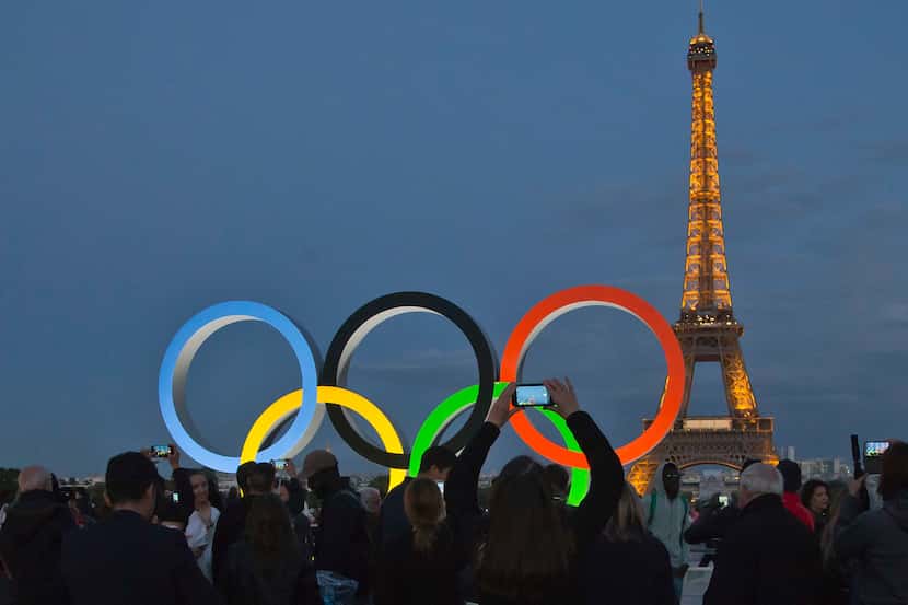 FILE - The Olympic rings are set up on Trocadero plaza that overlooks the Eiffel Tower, a...