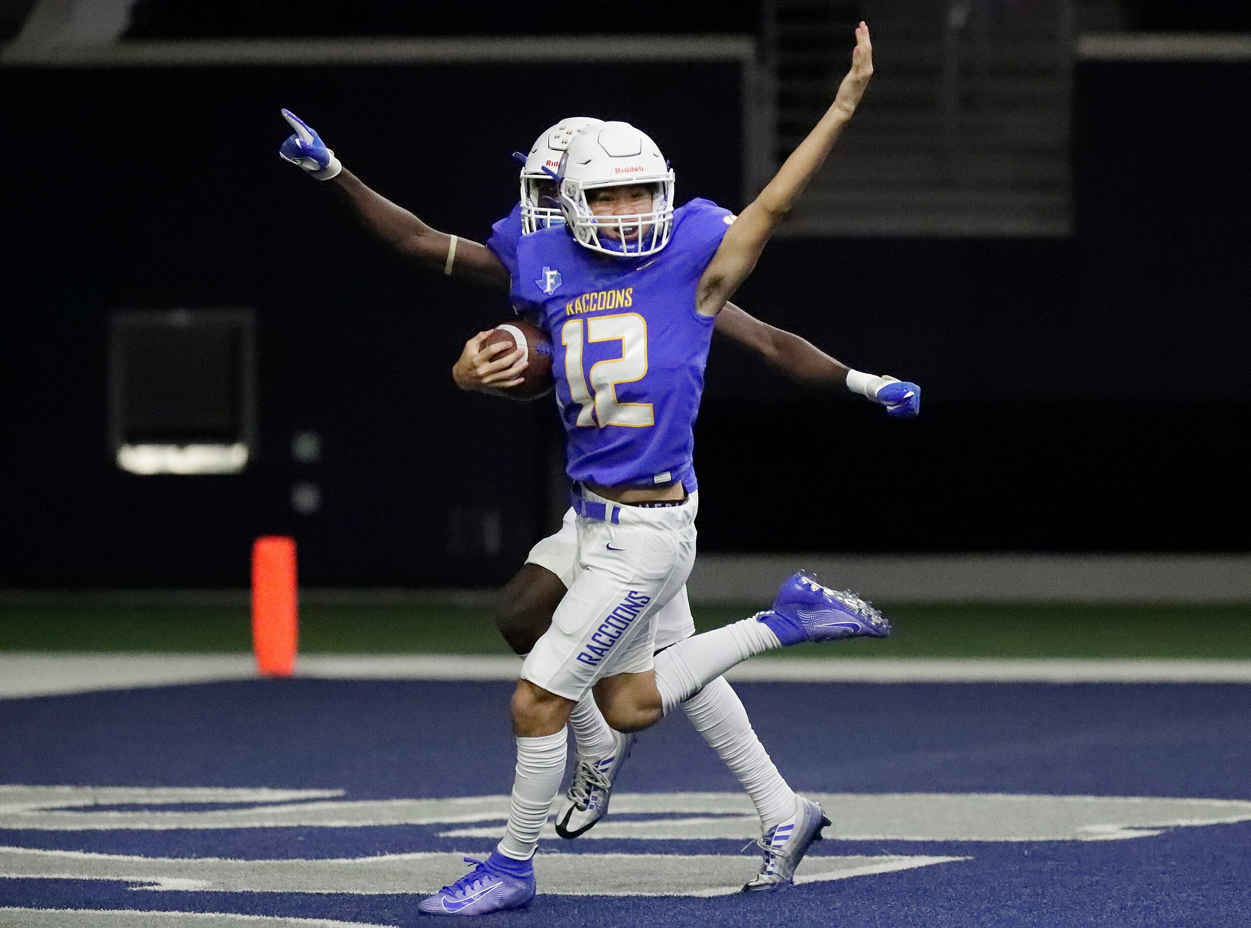 Frisco High School defender Evan Nguyen (12) scoops up a fumble on a punt return and is...