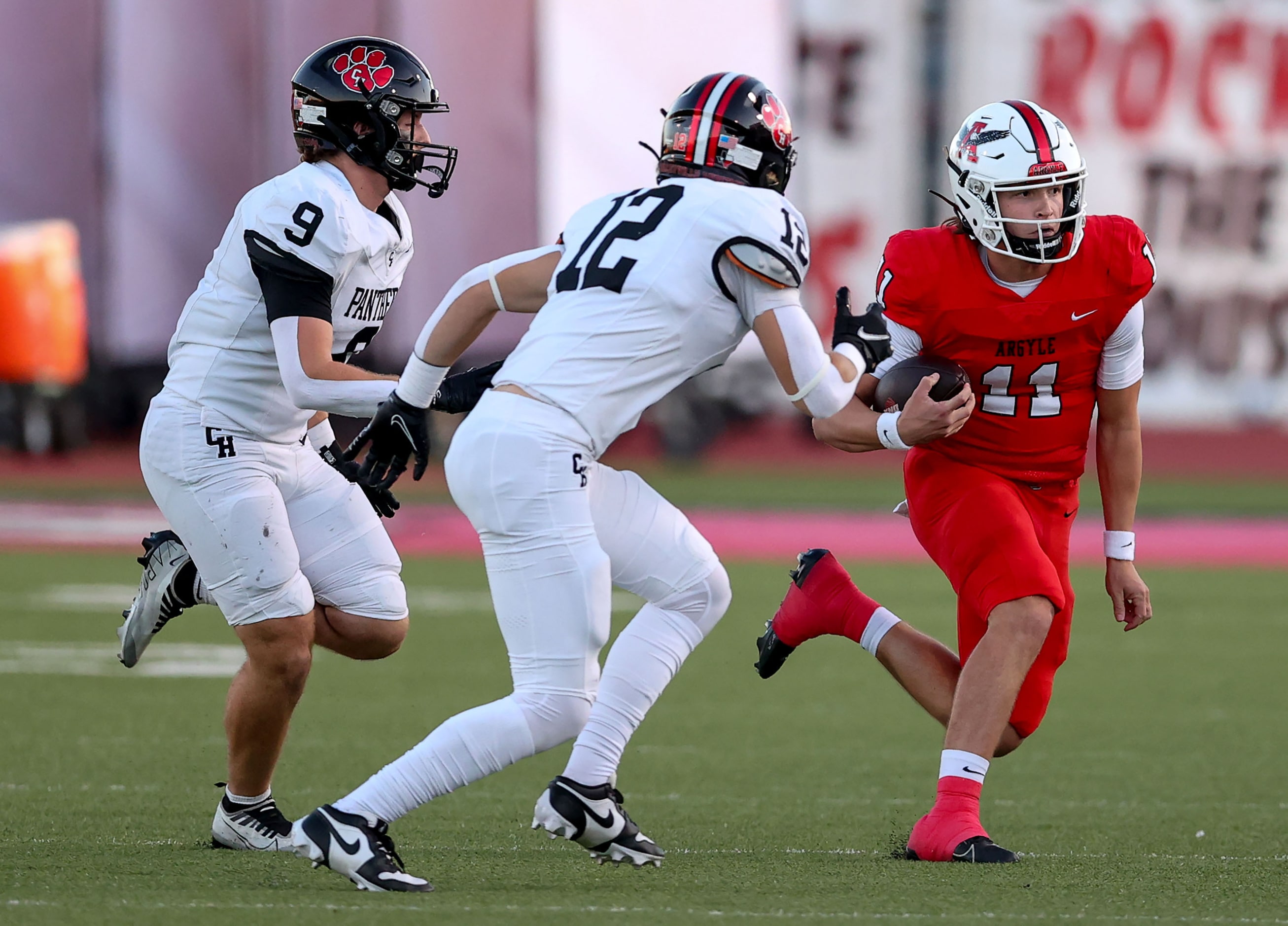 Argyle quarterback Maguire Gasperson (11) tries to elude Colleyville Heritage linebacker Dax...