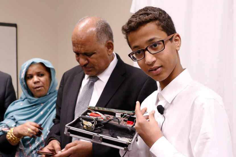 Ahmed Mohamed, right, labeled "Clock Boy" shows the clock he built in a school pencil box...