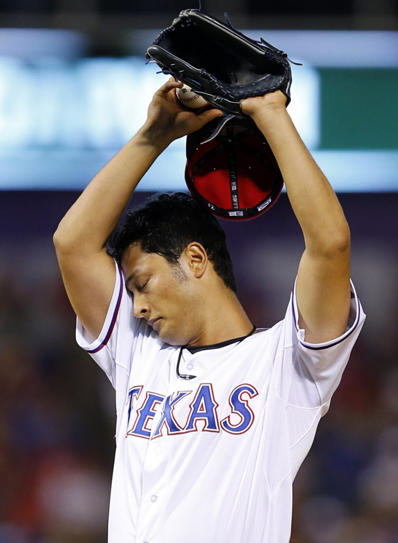 Texas Rangers starting pitcher Yu Darvish (11) wipes his brow after walking Houston Astros...