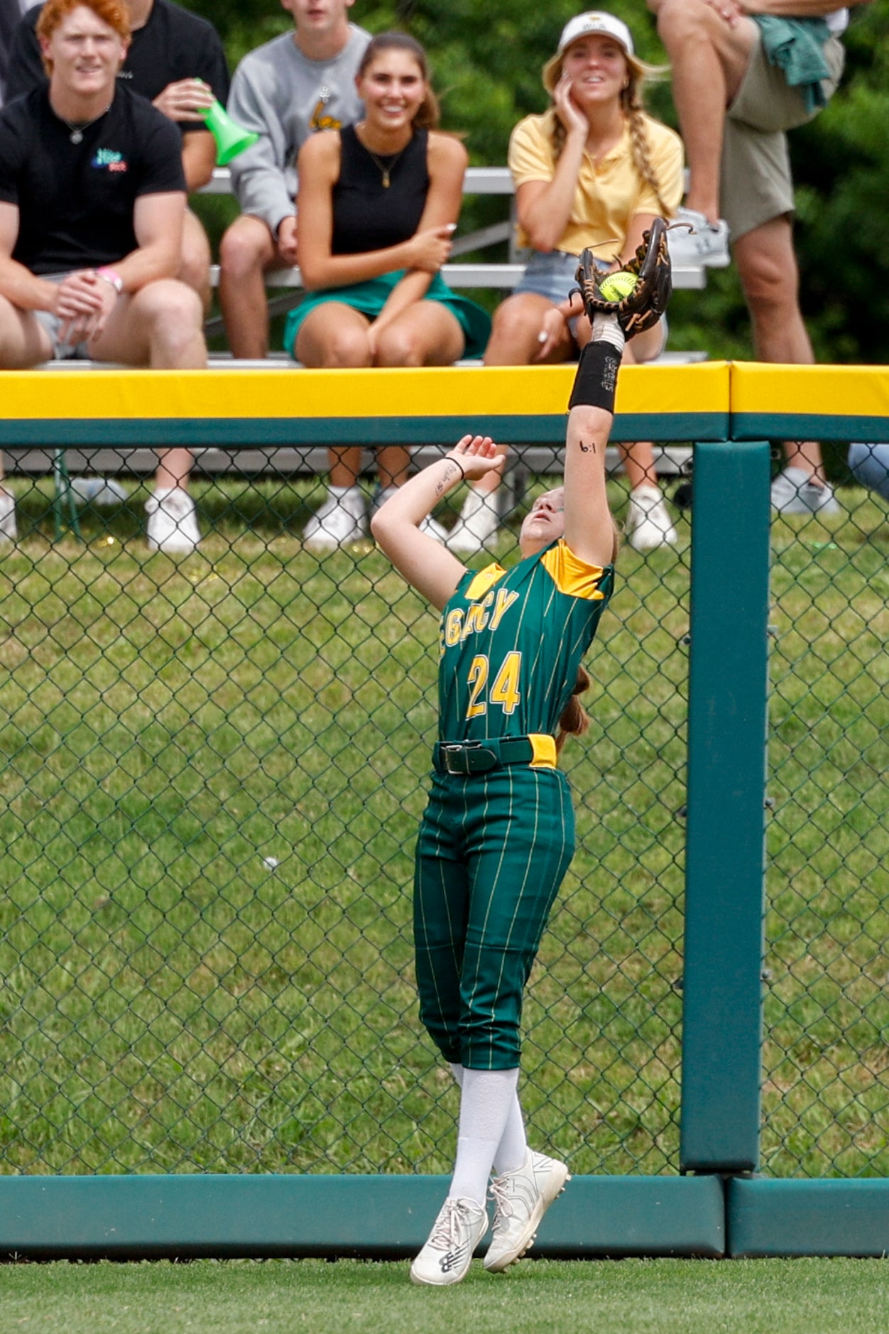 Frisco Legacy Christian outfielder Kylie Carlock (24) reaches back to make a catch for an...