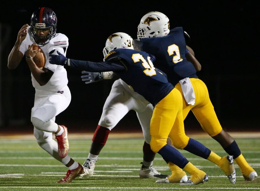 Bishop Dunne quarterback Caleb Evans (6) avoids a tackle by Prestonwood Christian linebacker...