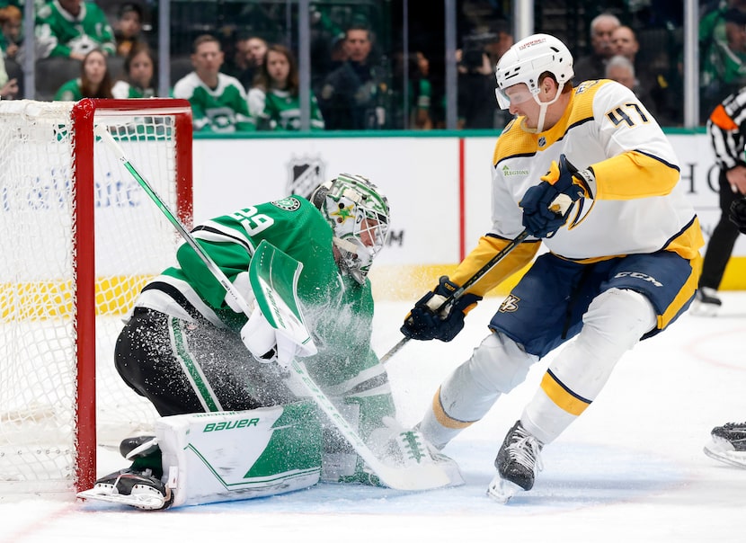 Dallas Stars goaltender Jake Oettinger (29) stops a shot as Nashville Predators right wing...