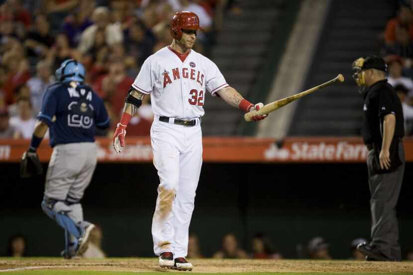 The Los Angeles Angels' Josh Hamilton walks back to the dugout after striking out swinging...