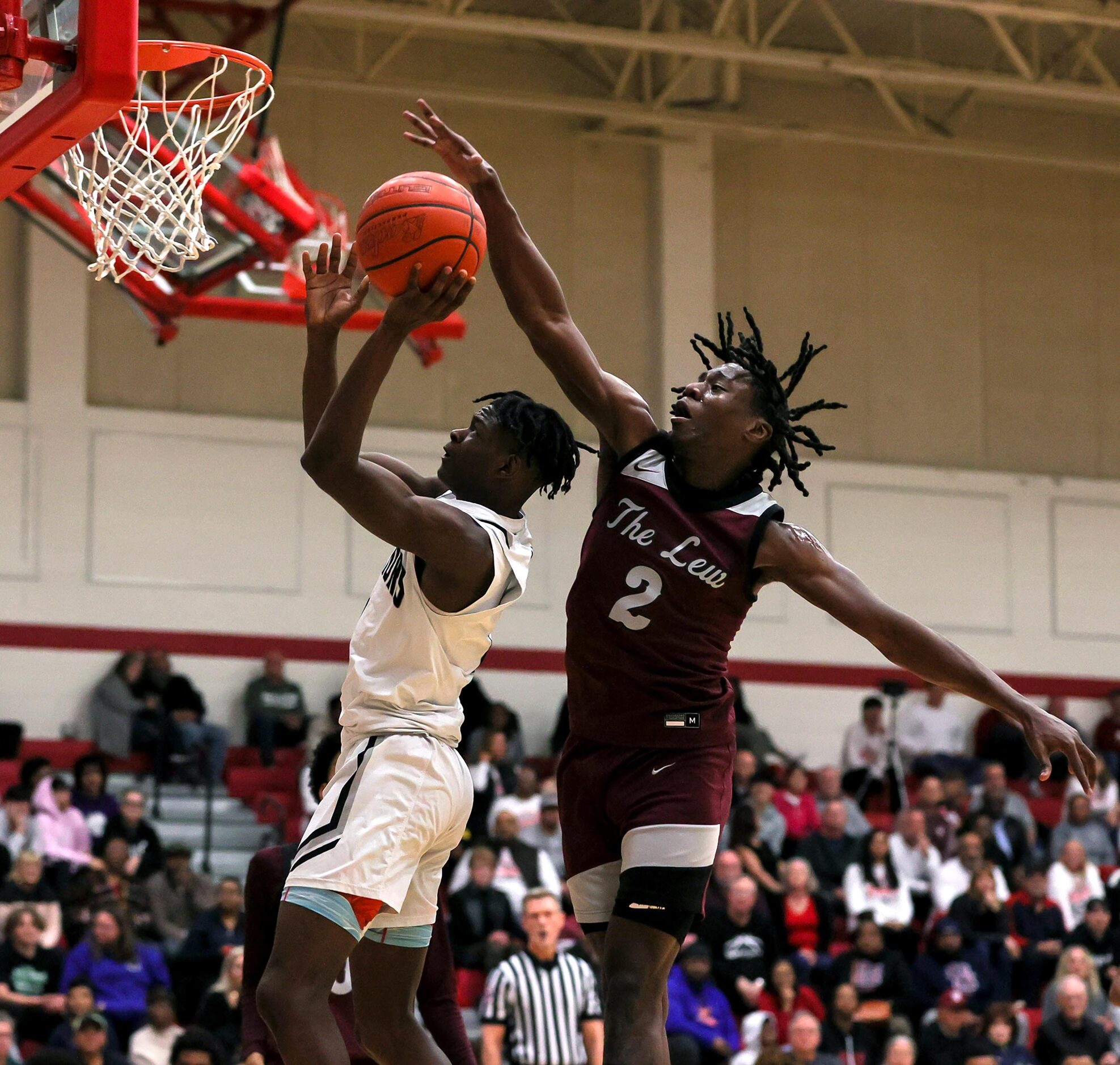 Arlington Martin guard Jeremiah Charles, (left) goes past Lewisville forward Jameer Lewis...