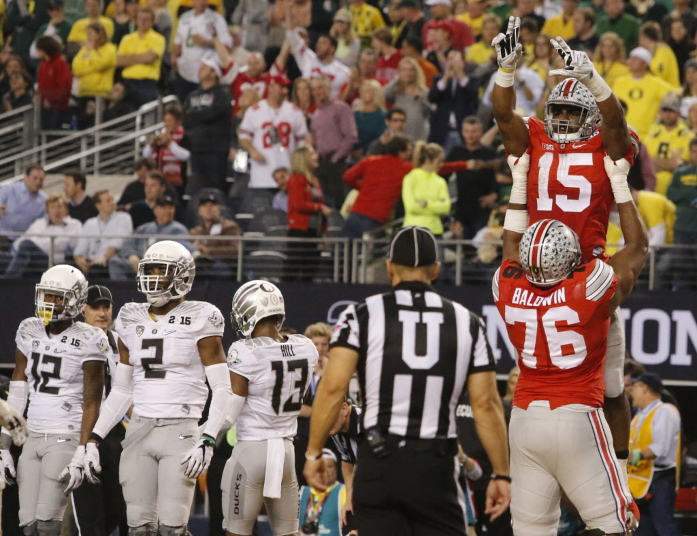 Ohio State Buckeyes running back Ezekiel Elliott (15) pick up by  offensive lineman Darryl...