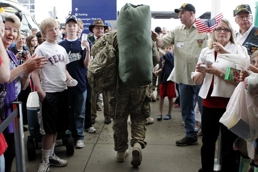 Family, friends and volunteers greet troops on March 14, 2012, at Dallas-Fort Worth...