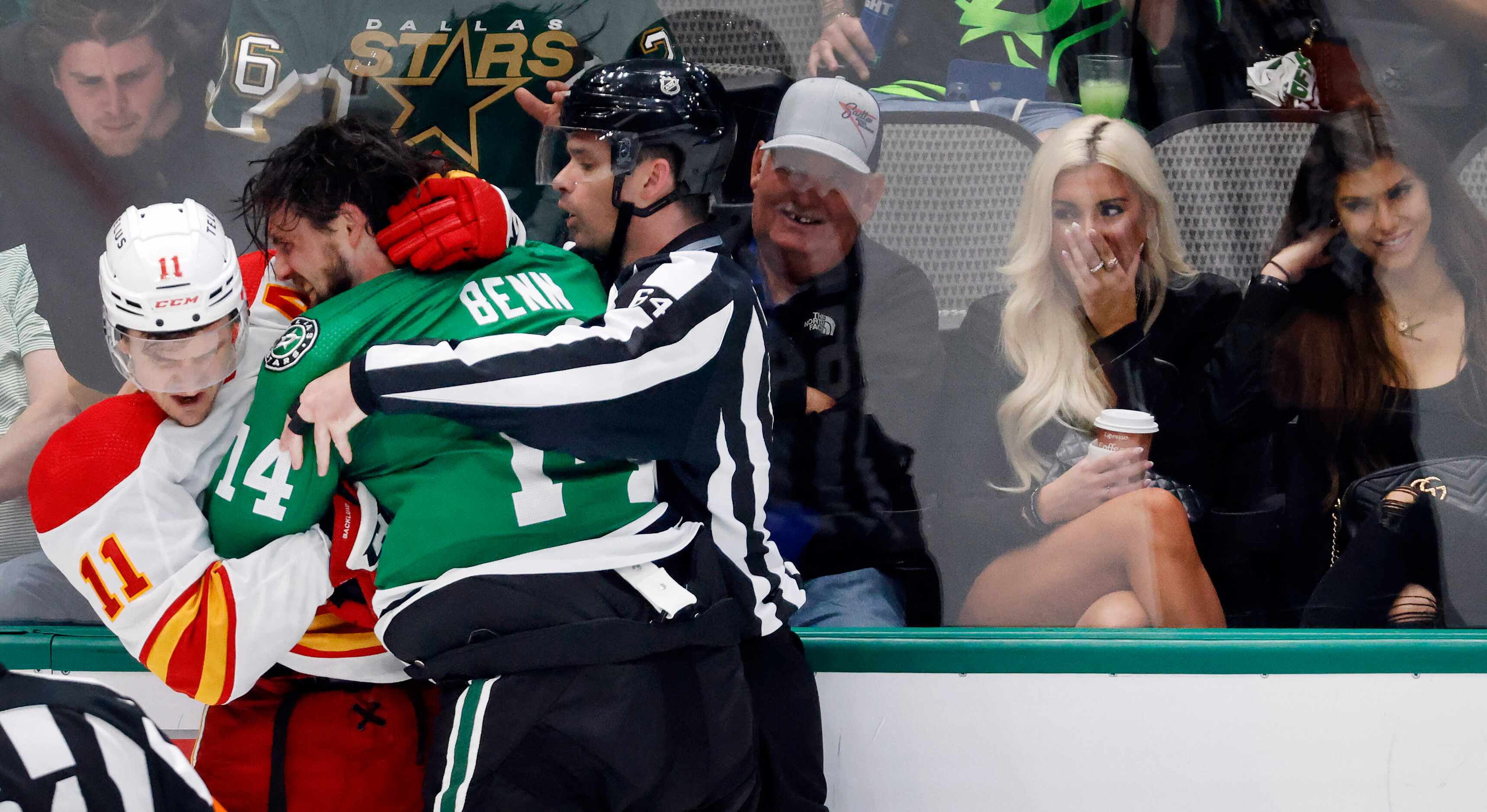 A pair of women in the front row react as Dallas Stars left wing Jamie Benn (14) and Calgary...