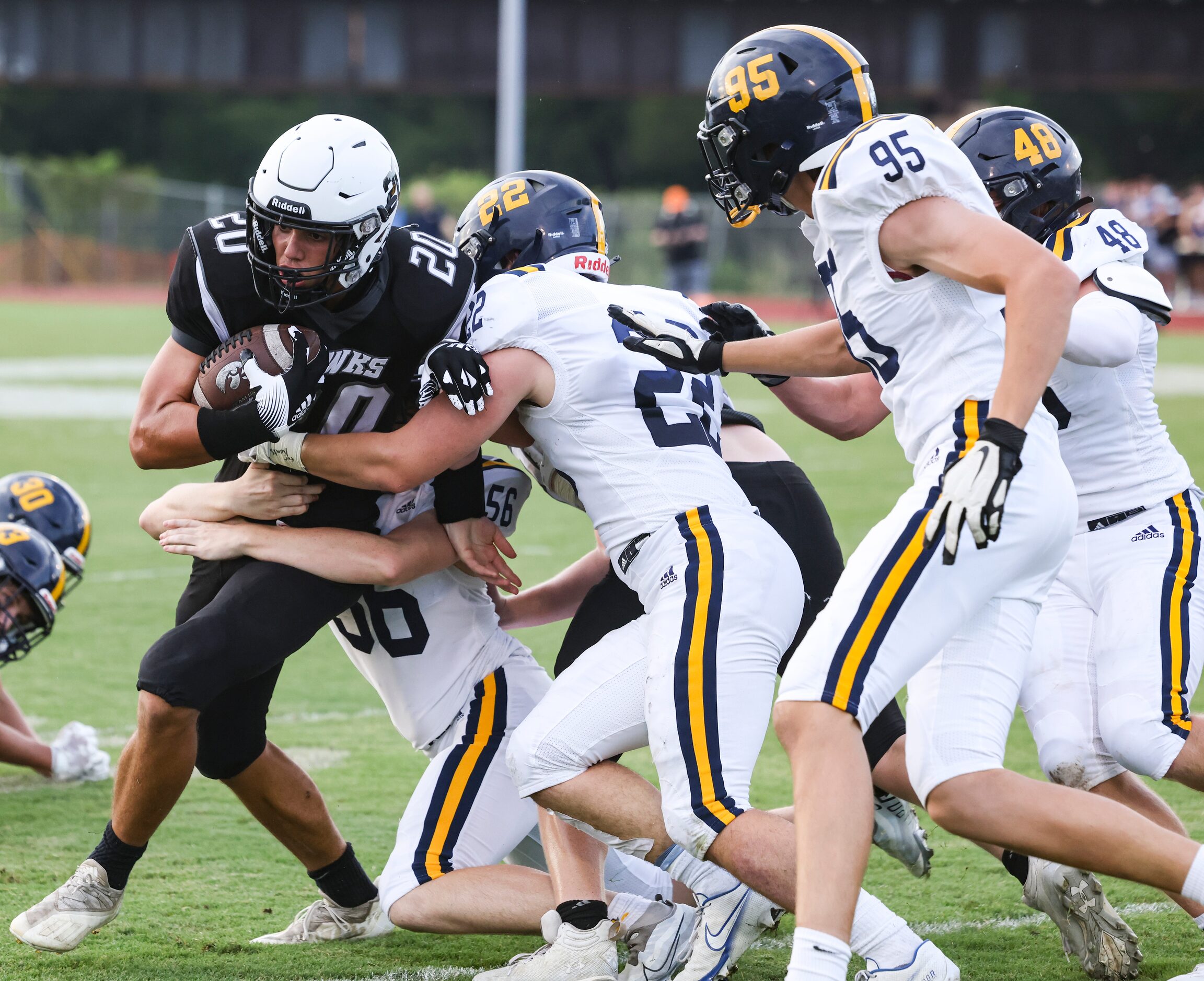 Cistercian Preparatory School  Michael Peterman (20) gets tackled by St. Mark's School of...