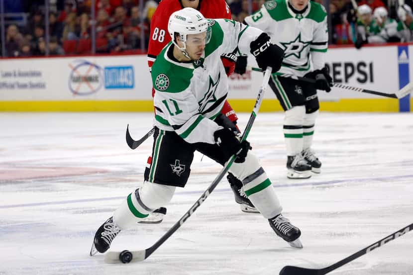 Dallas Stars' Logan Stankoven (11) shoots the puck against the Carolina Hurricanes during...