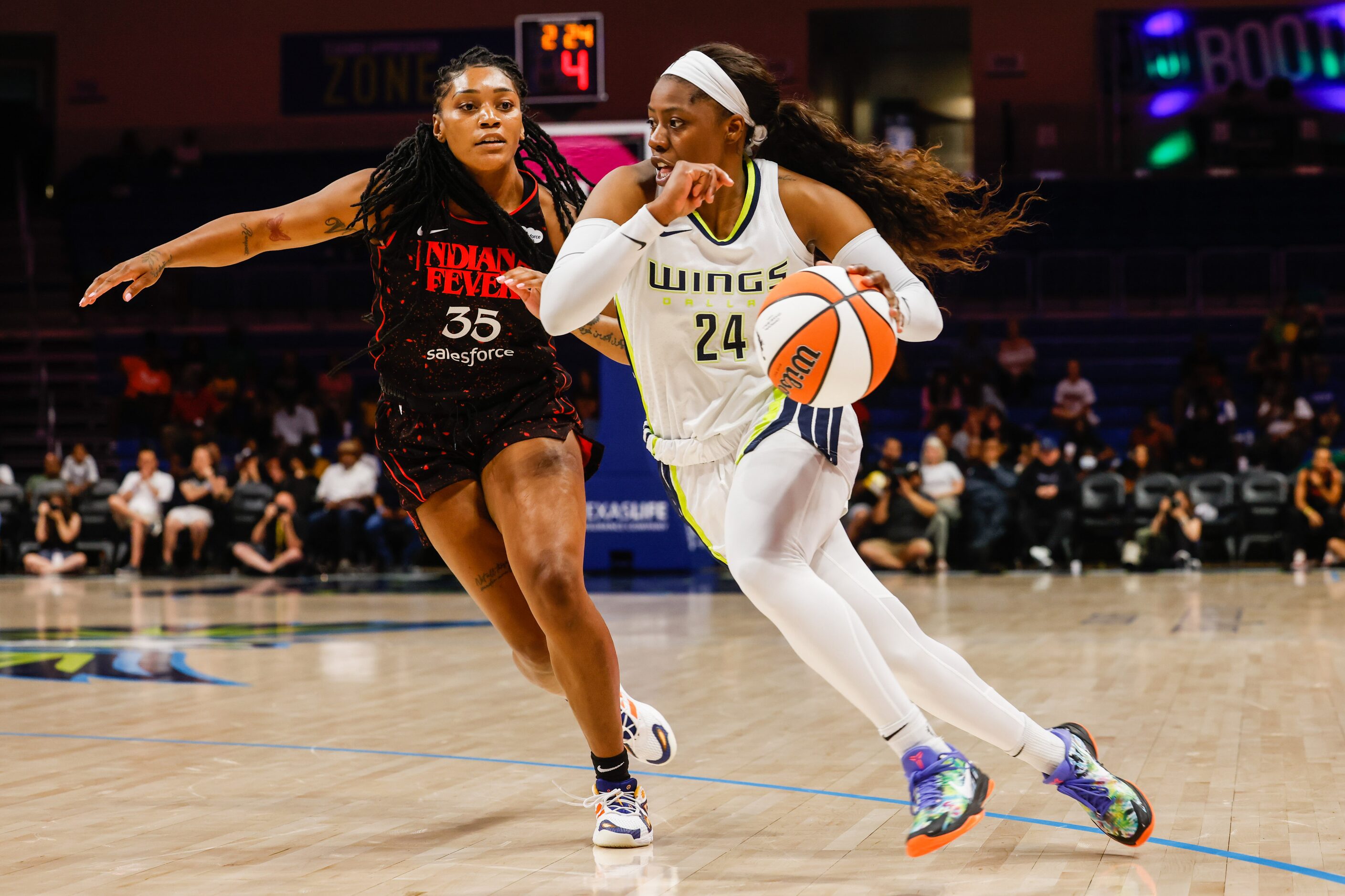 Dallas Wings guard Arike Ogunbowale (24) goes around Indiana Fever guard Victoria Vivians...