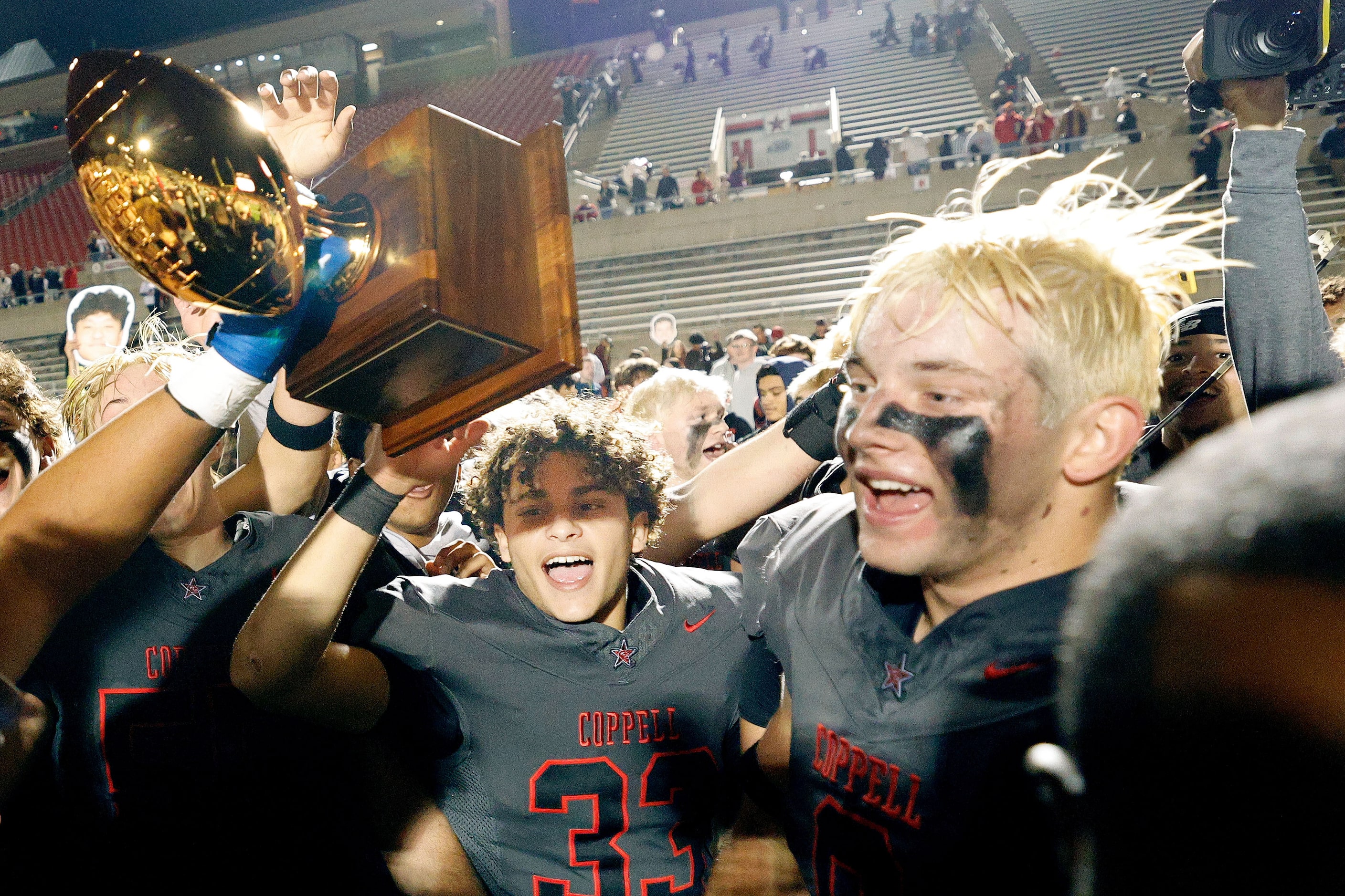 Coppell players celebrate their 35-27 victory against Prosper after a high school football...