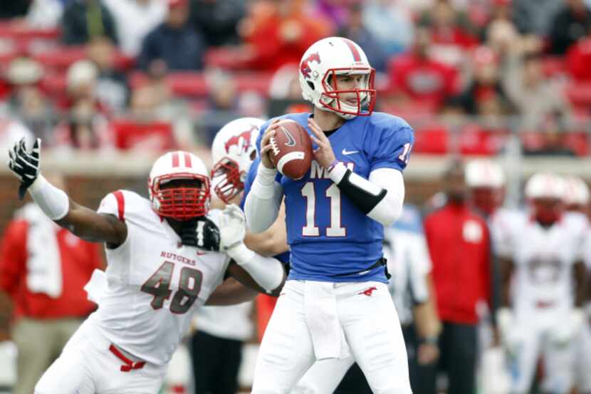 SMU quarterback Garrett Gilbert (11) looks down field as Rutgers defensive end Marcus...
