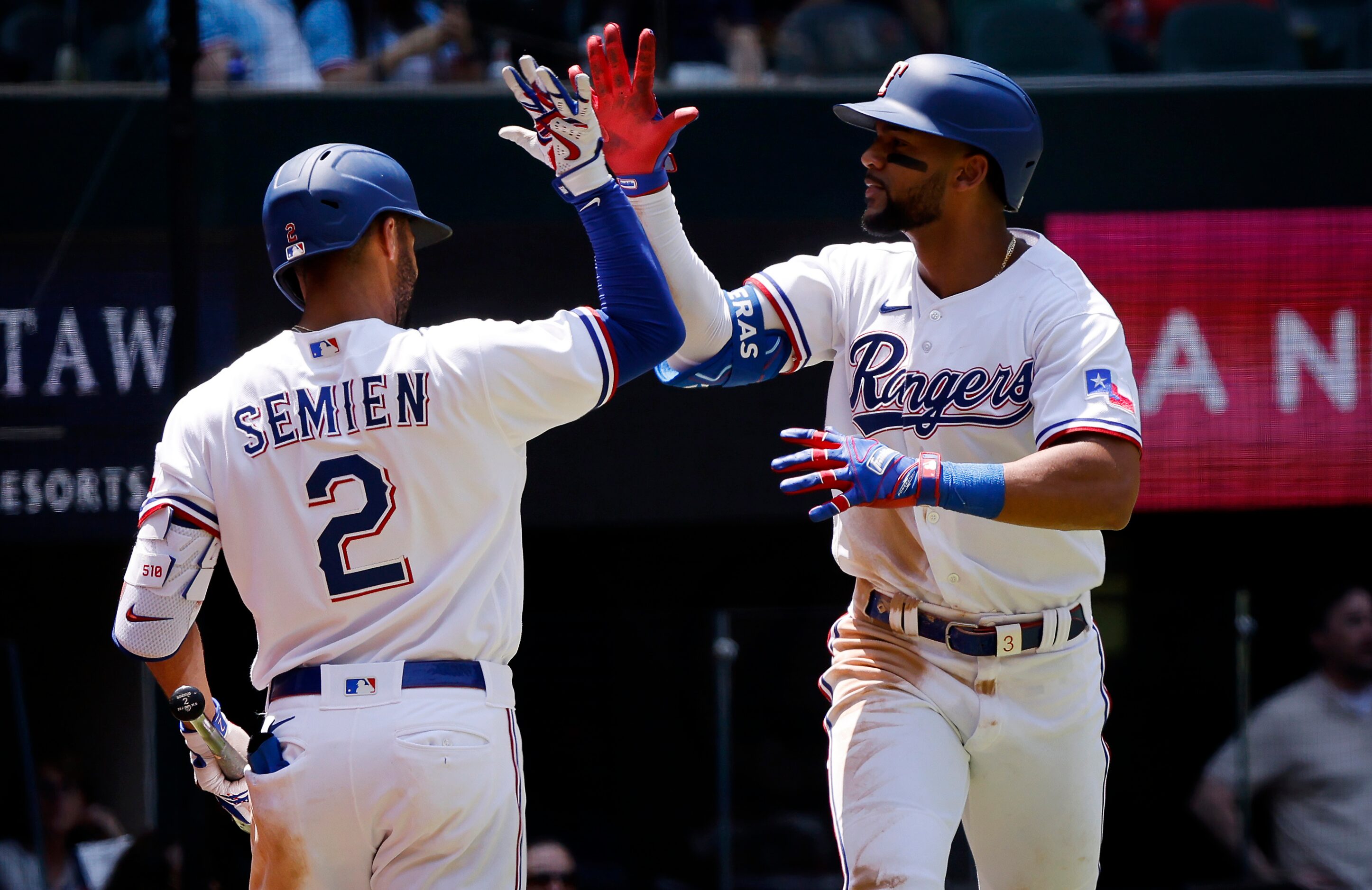 Texas Rangers center fielder Leody Taveras (right) is congratulate by teammate Marcus Semien...