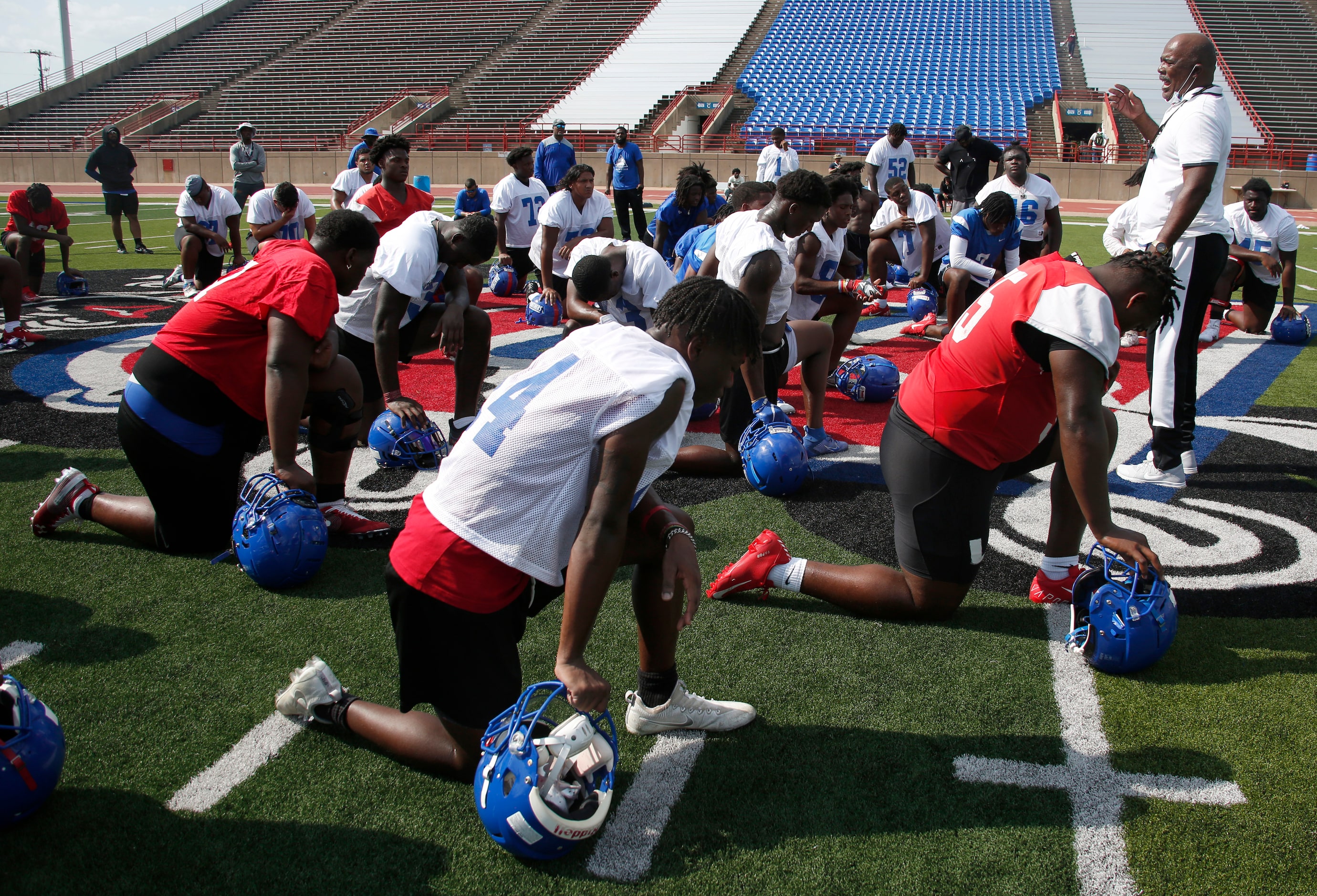 Duncanville Panthers varsity head coach Reginald Samples speaks with his players at the...