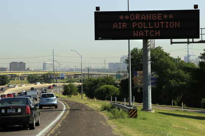 A highway sign alerts drivers on Interstate 35E northbound to air pollution conditions on...