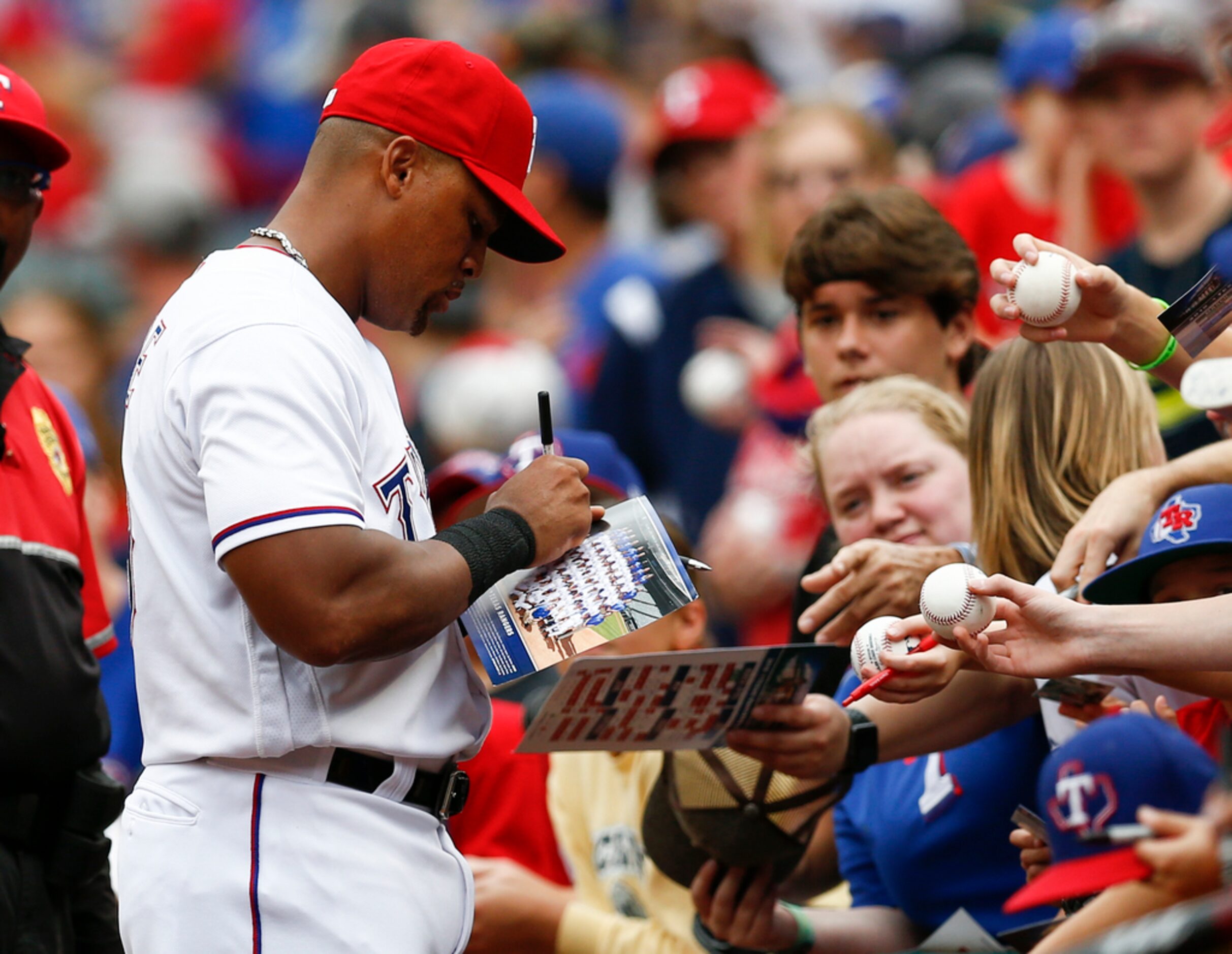 Texas Rangers' Adrian Beltre gives autographs to fans before his team's baseball game...